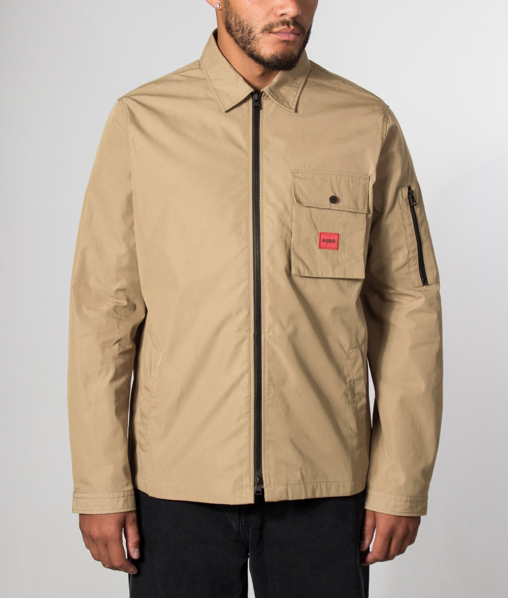 HUGO Relaxed Fit Emmond Zip Through Overshirt in Beige Overflow at EQVVS Menswear. Model front shot.