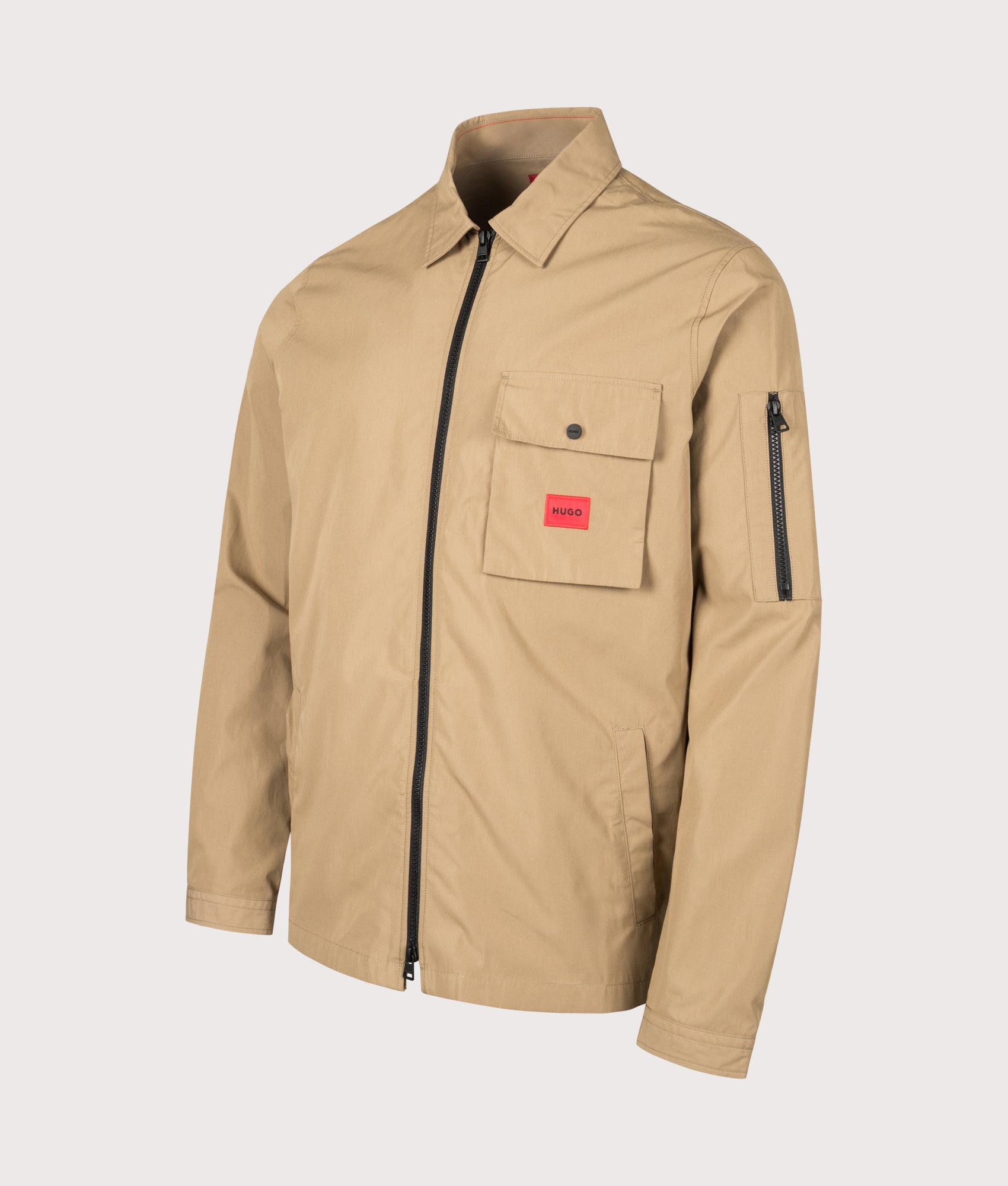 HUGO Relaxed Fit Emmond Zip Through Overshirt in Beige Overflow at EQVVS Menswear. Angled front shot.