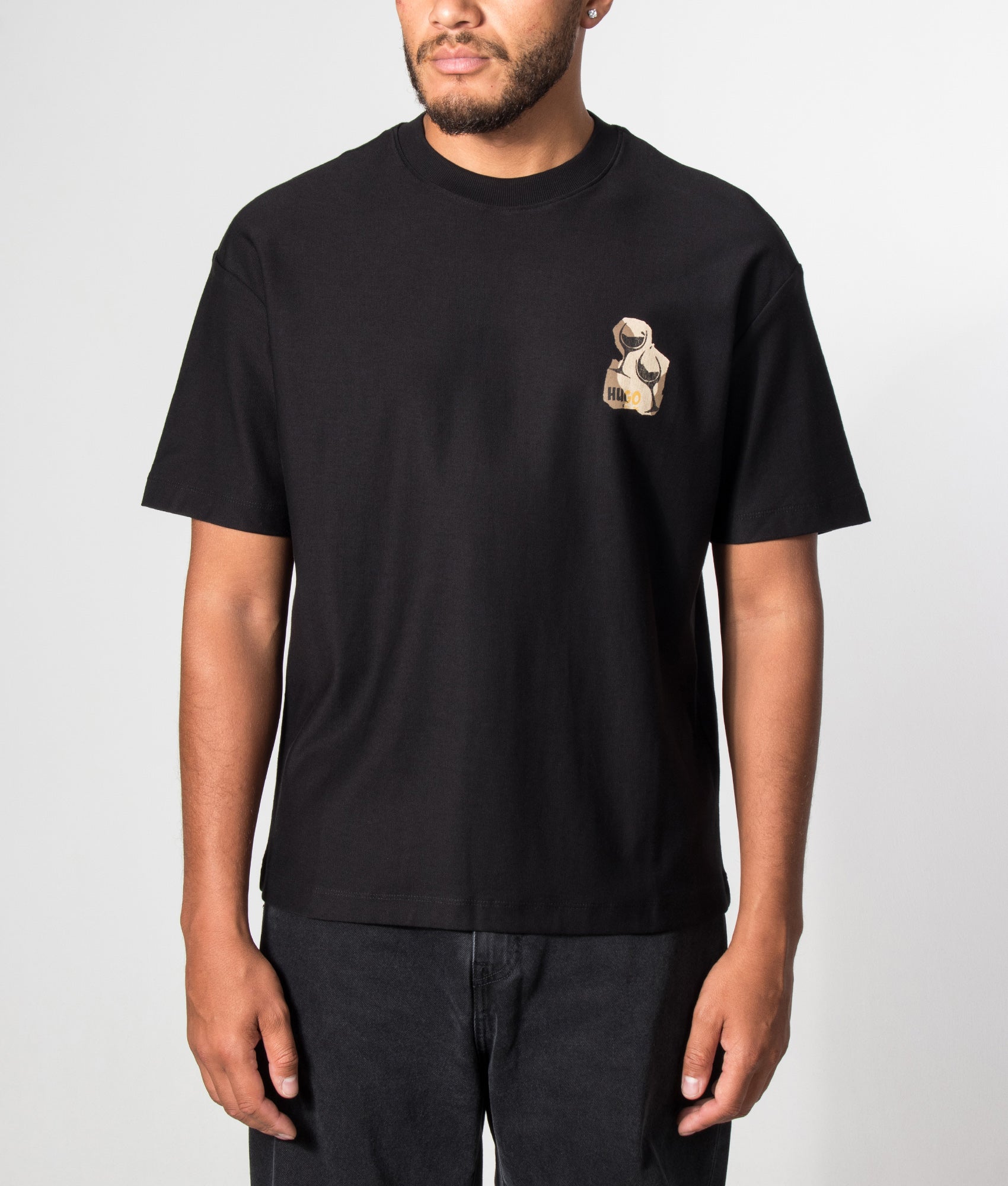 HUGO Relaxed Fit Detzi T-Shirt in Black at EQVVS Menswear. Model front shot.