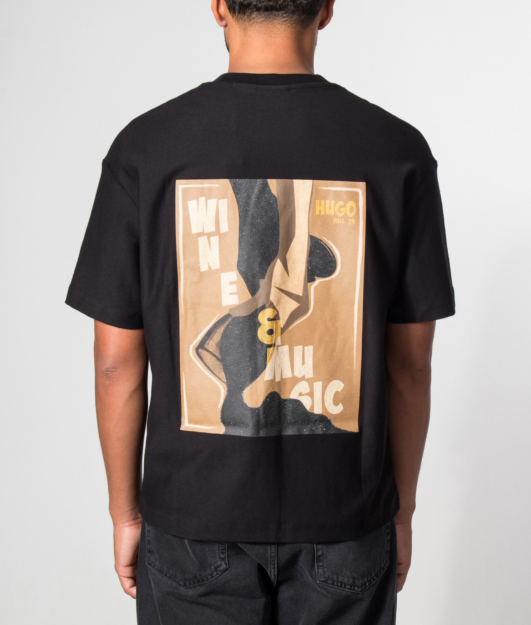 HUGO Relaxed Fit Detzi T-Shirt in Black at EQVVS Menswear. Model back shot.