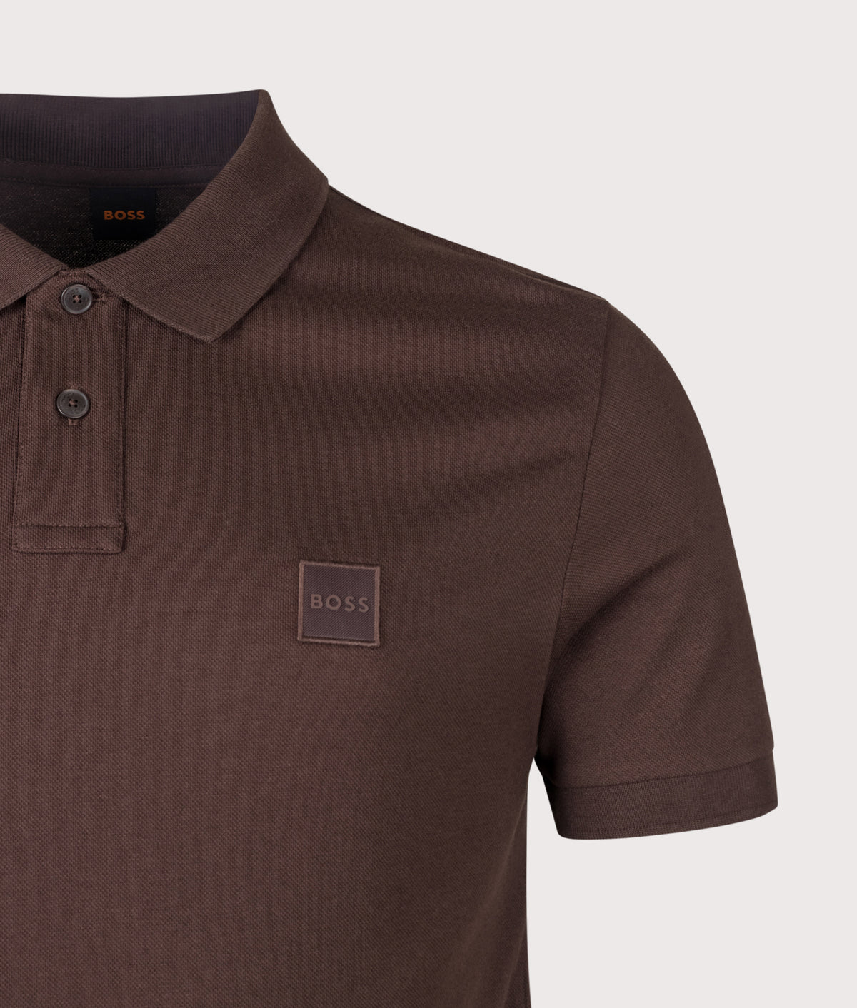 BOSS Slim Fit Passenger Polo Shirt in Dark Brown at EQVVS Menswear. Detail shot.