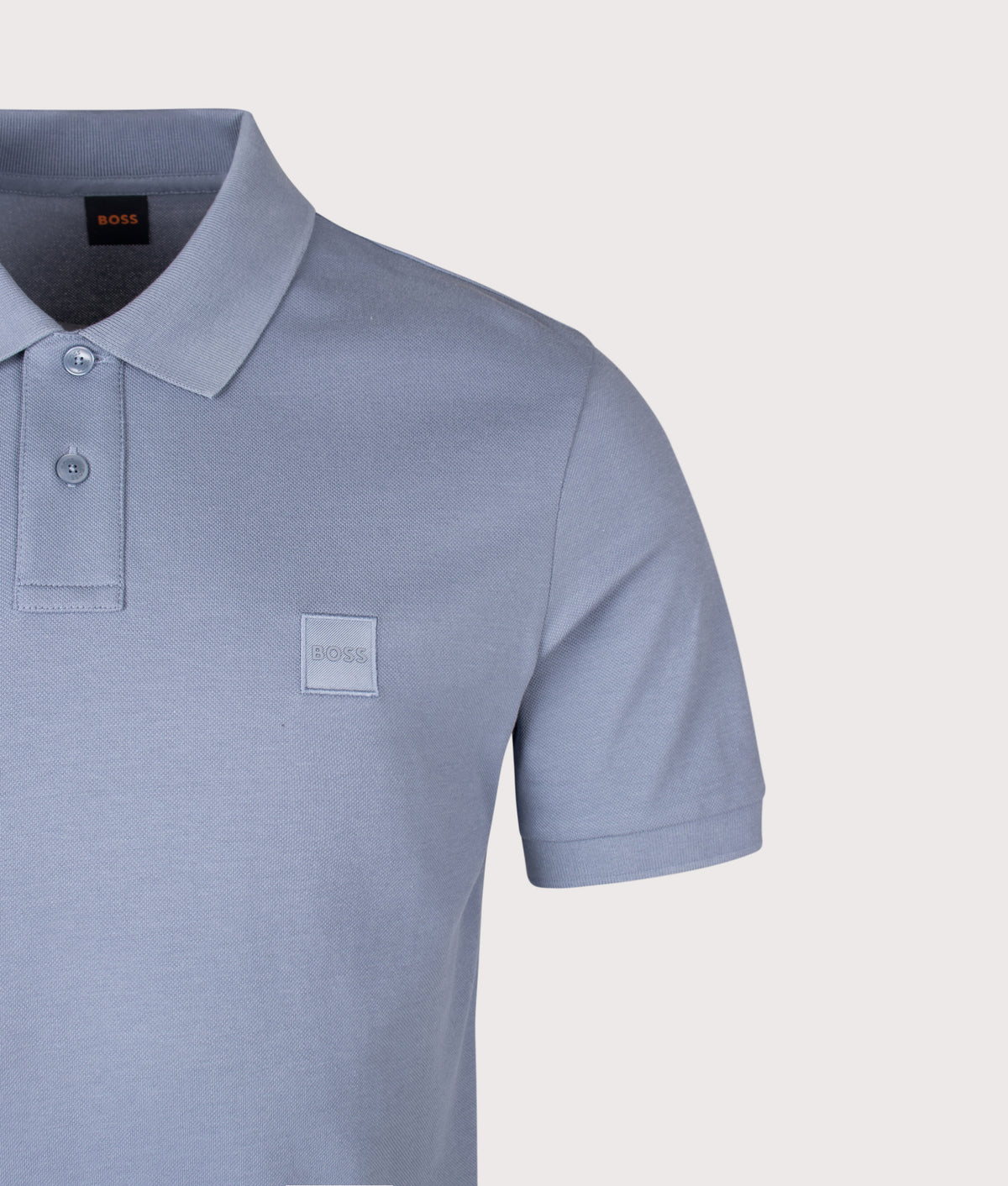BOSS Slim Fit Passenger Polo Shirt in Medium Blue at EQVVS Menswear. Detail shot.