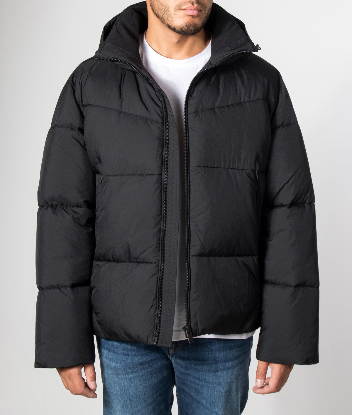BOSS Oversized Fit Obore Puffer Jacket in Black at EQVVS Menswear. Model front shot.