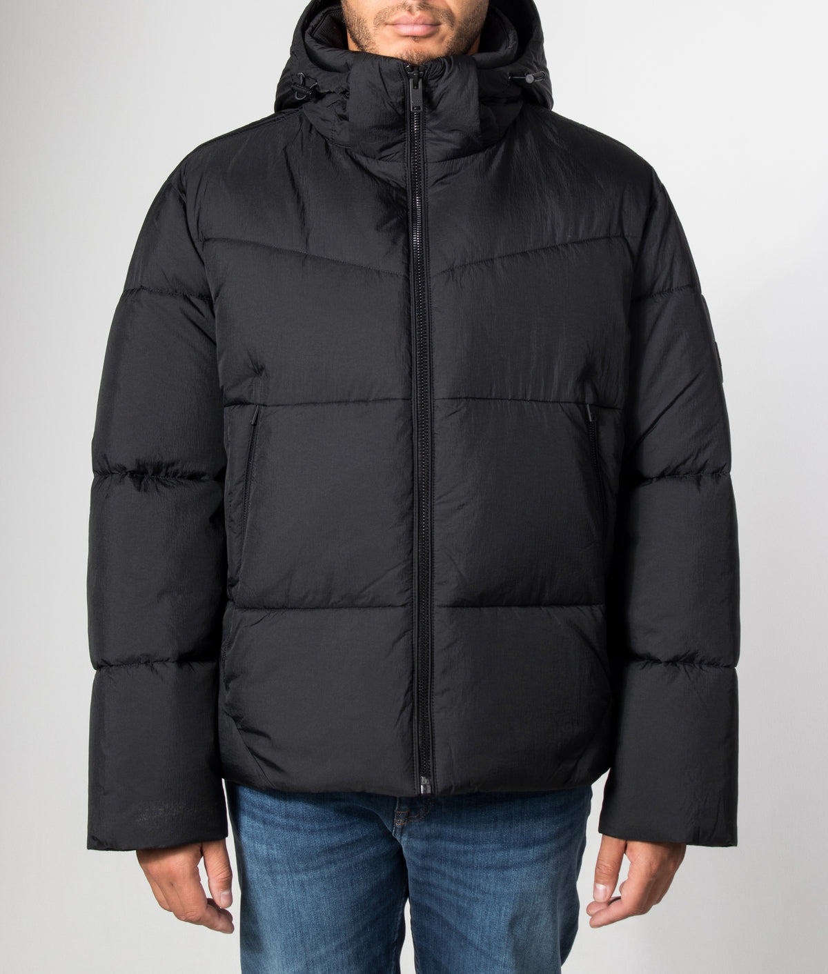 BOSS Oversized Fit Obore Puffer Jacket in Black at EQVVS Menswear. Model front shot.