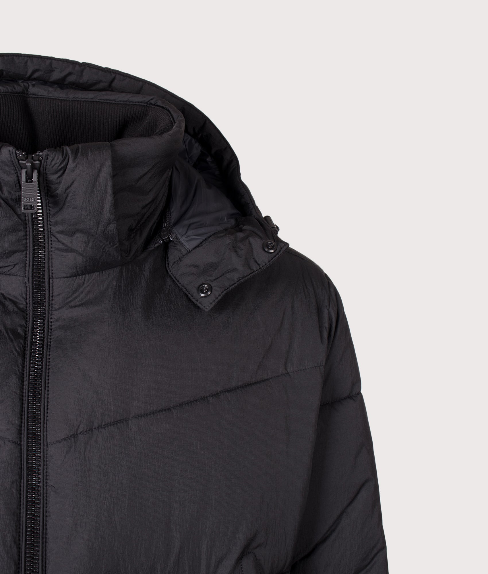 BOSS Oversized Fit Obore Puffer Jacket in Black at EQVVS Menswear. Hood shot.