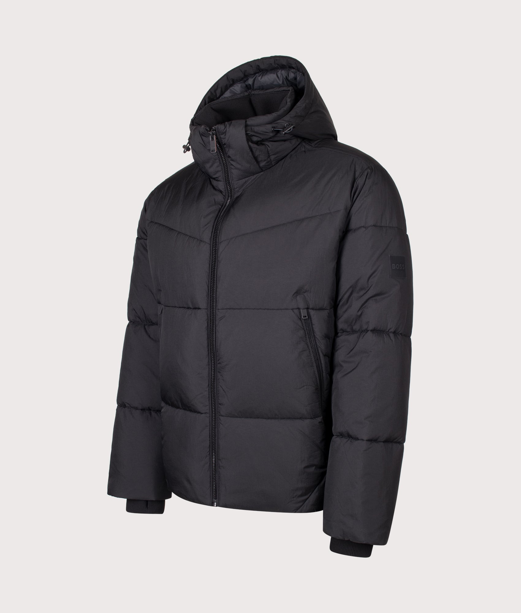 BOSS Oversized Fit Obore Puffer Jacket in Black at EQVVS Menswear. Angled font shot.