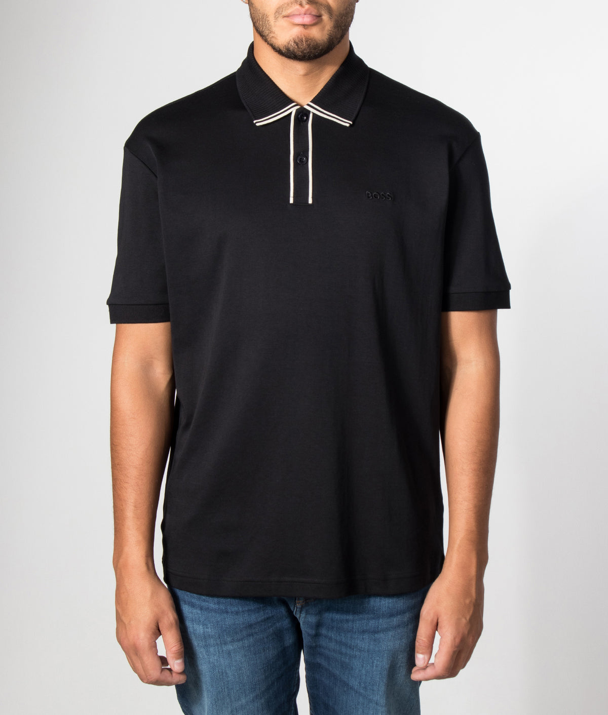BOSS Regular Fit PL Cord Paddy Polo Shirt in Black at EQVVS Menswear. Model front shot.