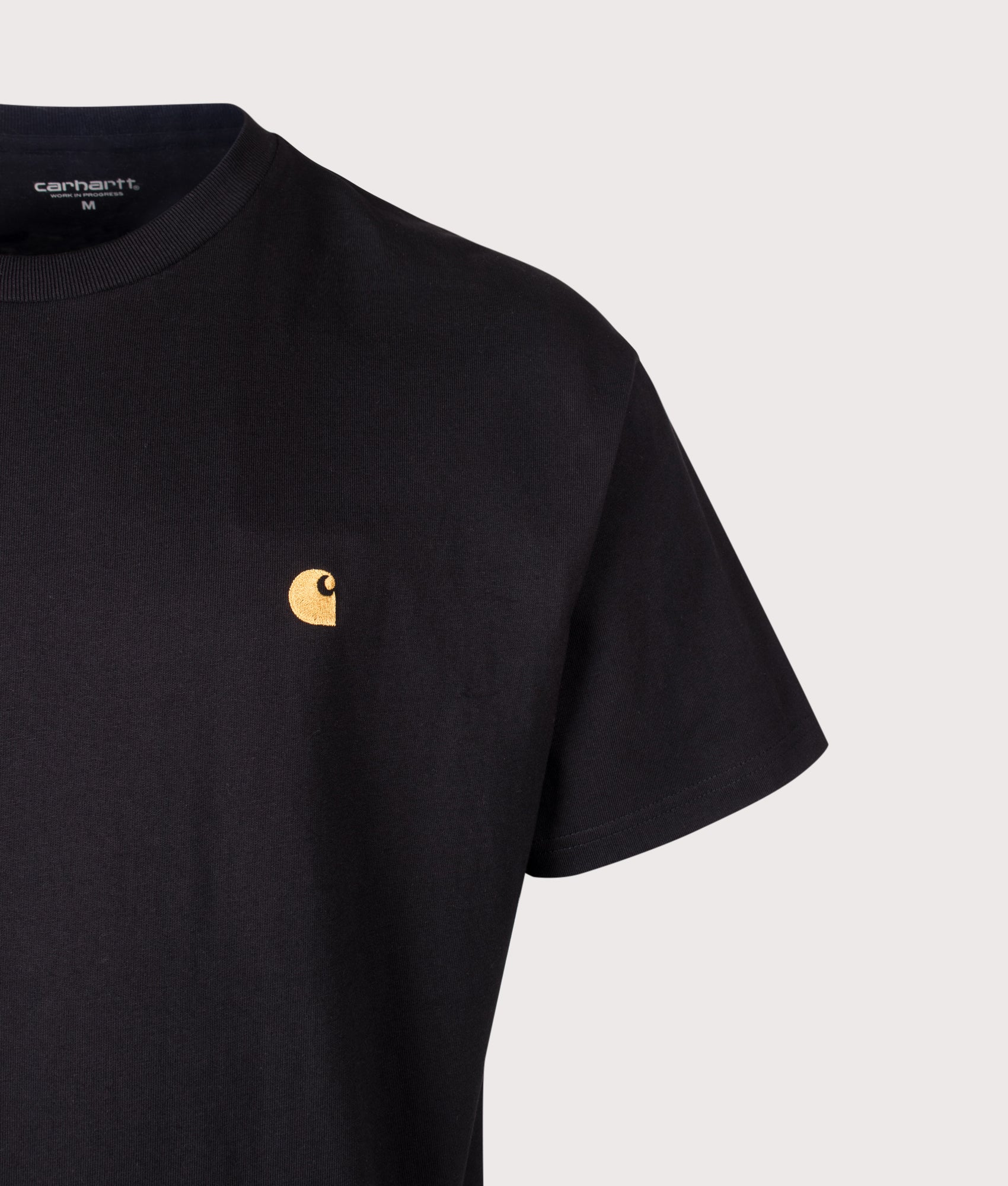 Carhartt WIP Loose Fit Chase T-Shirt in Black and Gold at EQVVS Menswear. Detail shot.