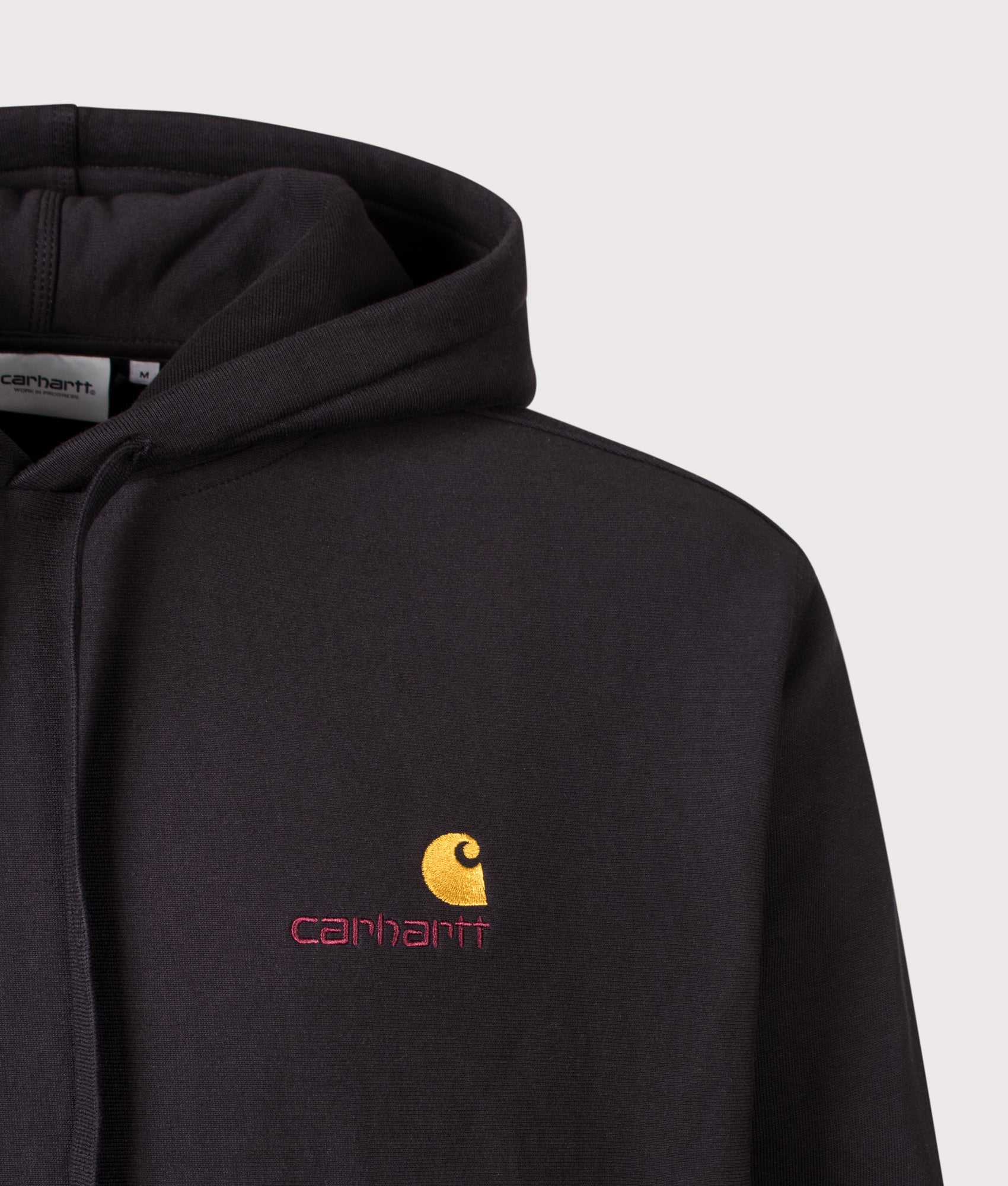 Carhartt WIP Loose Fit American Script Hoodie in Black at EQVVS Menswear. Detail shot.