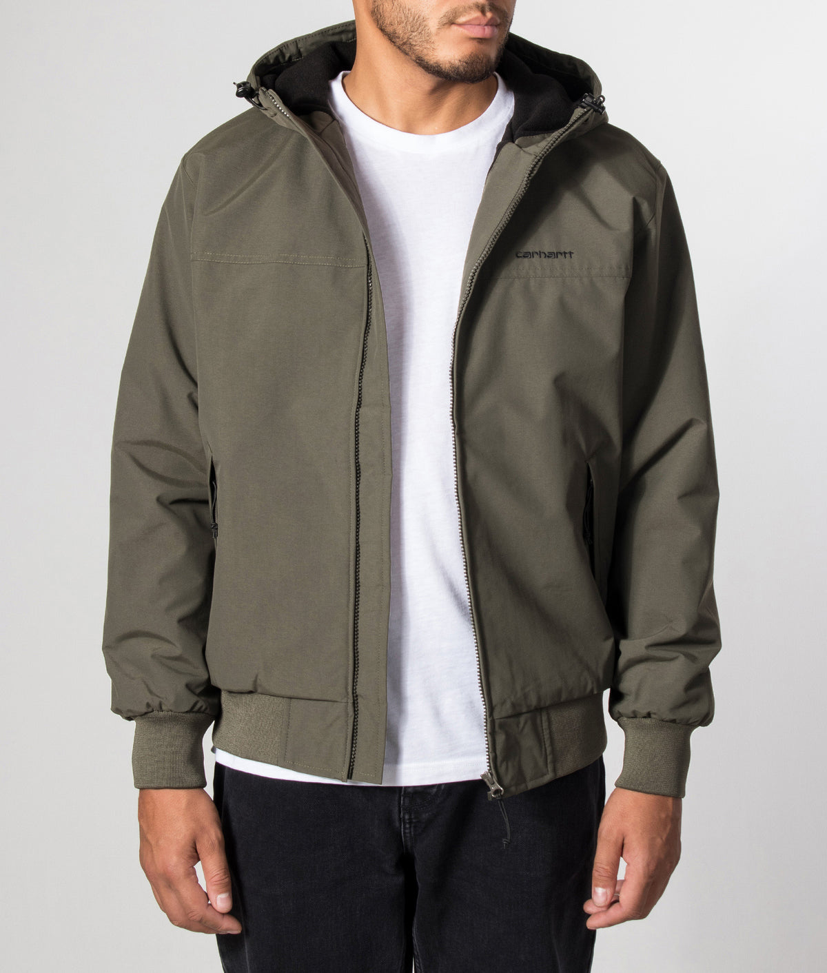 Carhartt WIP Regular Fit Hooded Sail Jacket in Cypress and Black at EQVVS Menswear. Model front shot.