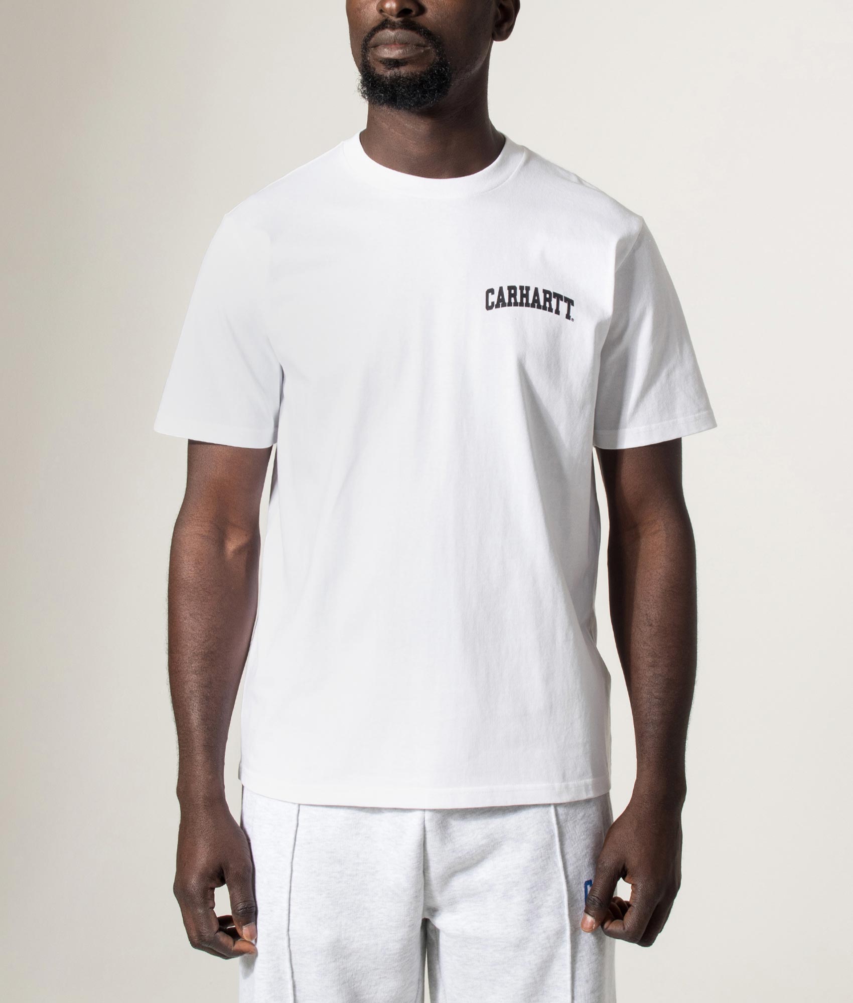Carhartt WIP University Script T-Shirt in White at EQVVS Menswear. Model front shot.