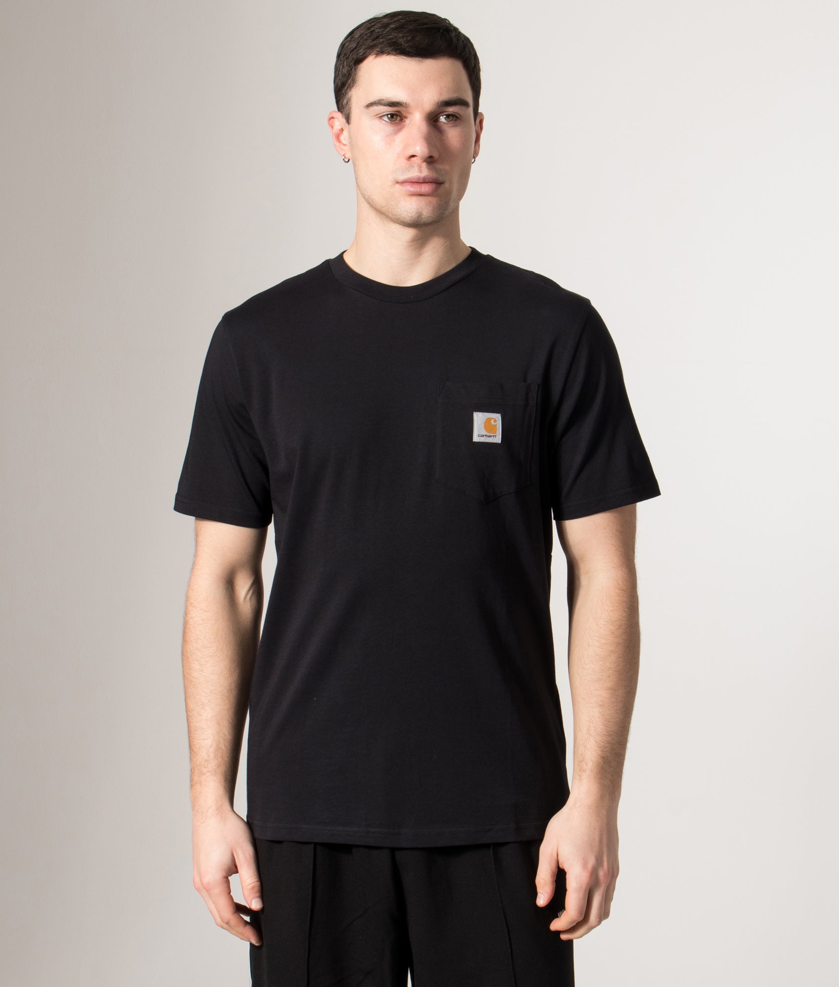 Carhartt WIP Pocket T-Shirt in Black at EQVVS Menswear. Model front shot.
