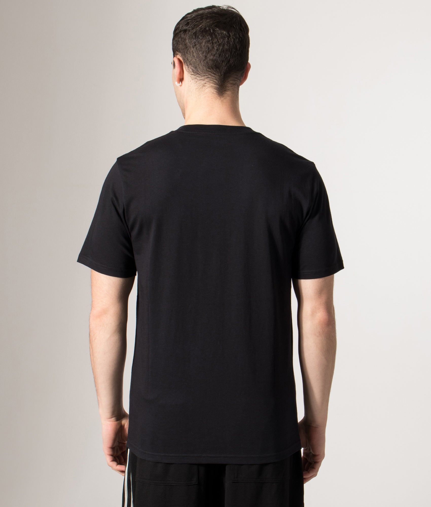 Carhartt WIP Pocket T-Shirt in Black at EQVVS Menswear. Model back shot.