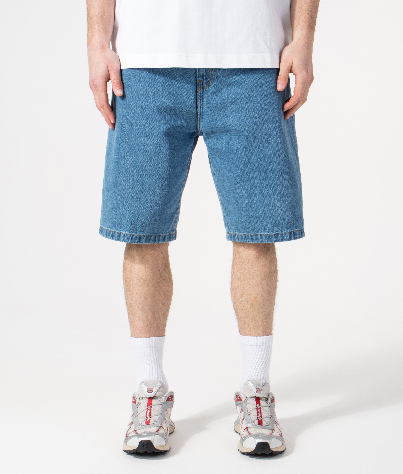 Carhartt WIP Relaxed Fit Landon Shorts in Blue Heavy Stone Wash at EQVVS Menswear. Model front shot.