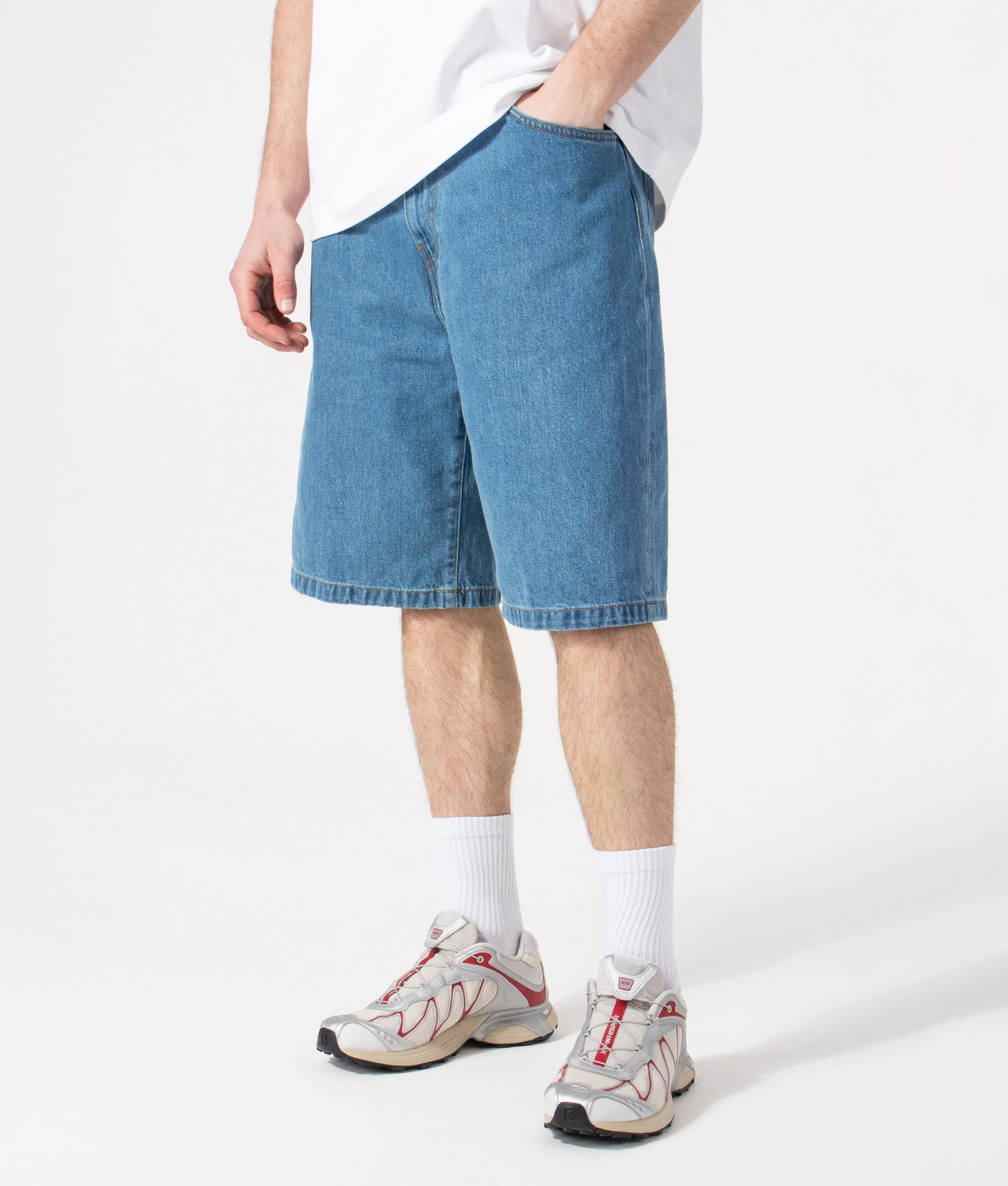 Carhartt WIP Relaxed Fit Landon Shorts in Blue Heavy Stone Wash at EQVVS Menswear. Angled model front shot.