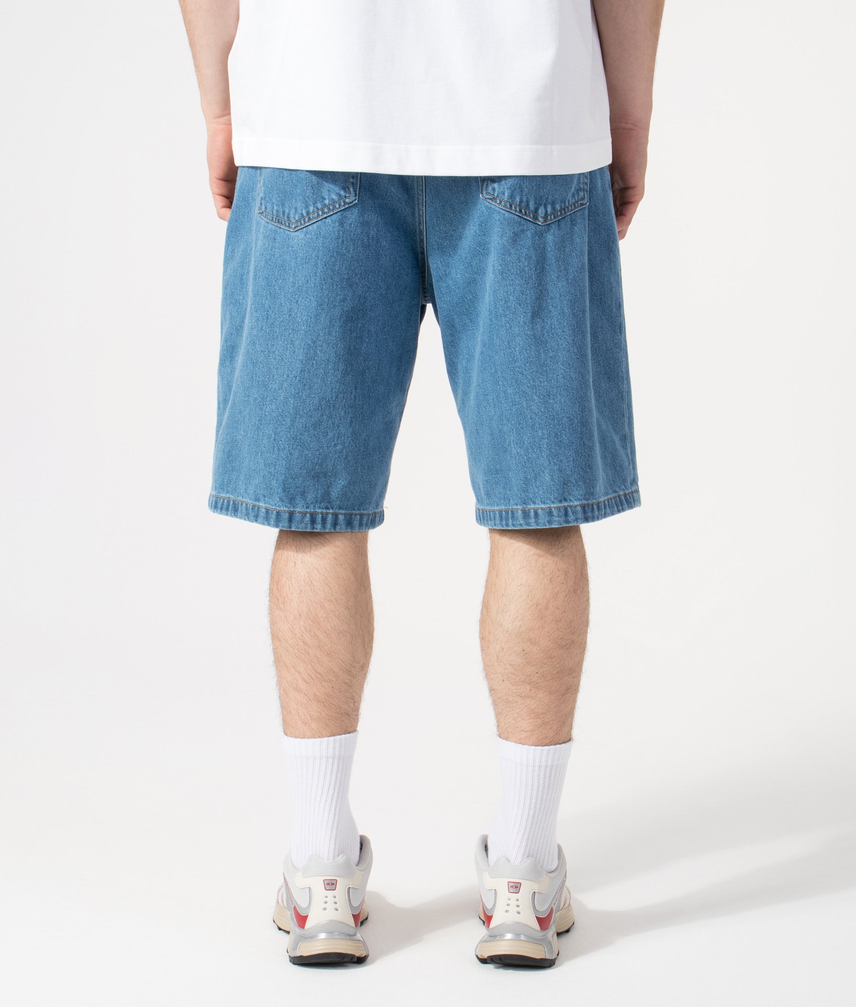 Carhartt WIP Relaxed Fit Landon Shorts in Blue Heavy Stone Wash at EQVVS Menswear. Model back shot.