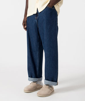 Carahrtt WIP Relaxed Fit Brandon Jeans in Blue Stone Washed Rolled up , 100% Cotton Angle Model Shot at EQVVS