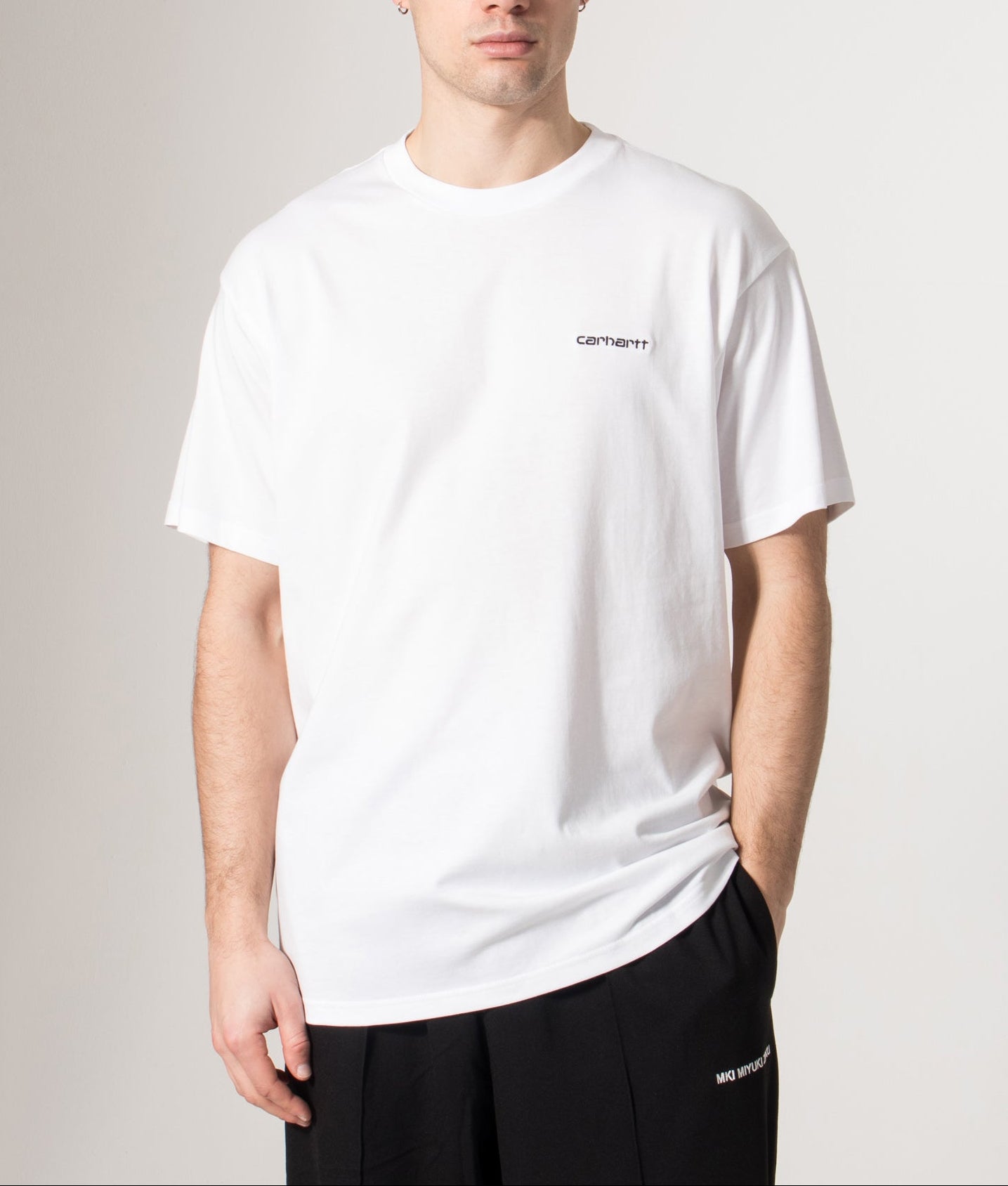 Carhartt WIP Loose Fit Script Embroidery T-Shirt in White and Black at EQVVS Menswear. Model front shot.