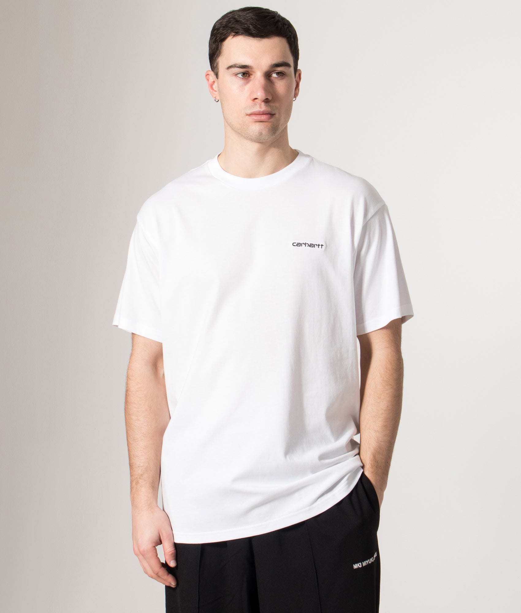 Carhartt WIP Relaxed Fit Script Embroidery T-Shirt in White and Black at EQVVS Menswear. Model front shot.