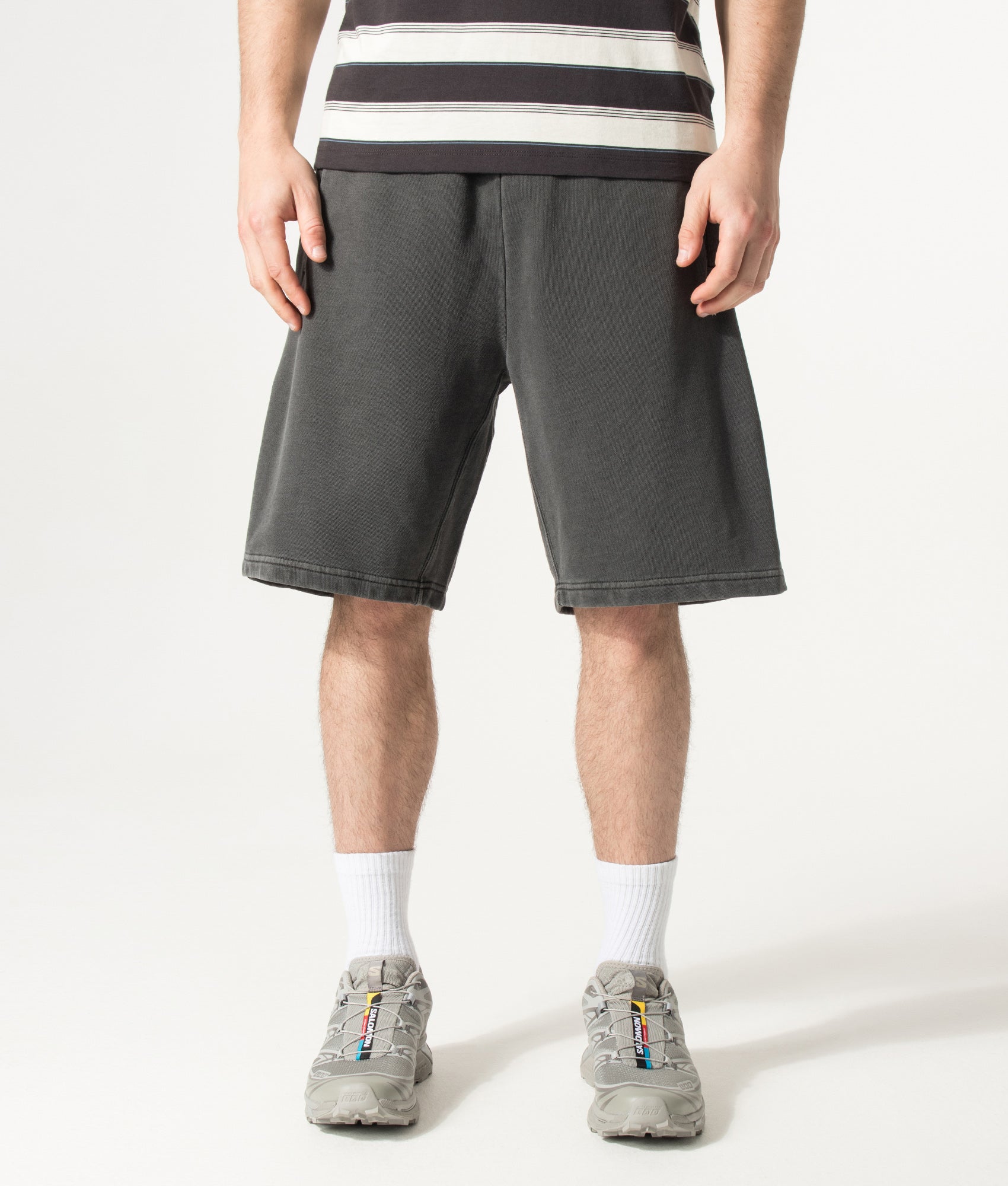 Carhartt WIP Balloon Fit Nelson Sweat Shorts in Black at EQVVS Menswear. Model front shot.