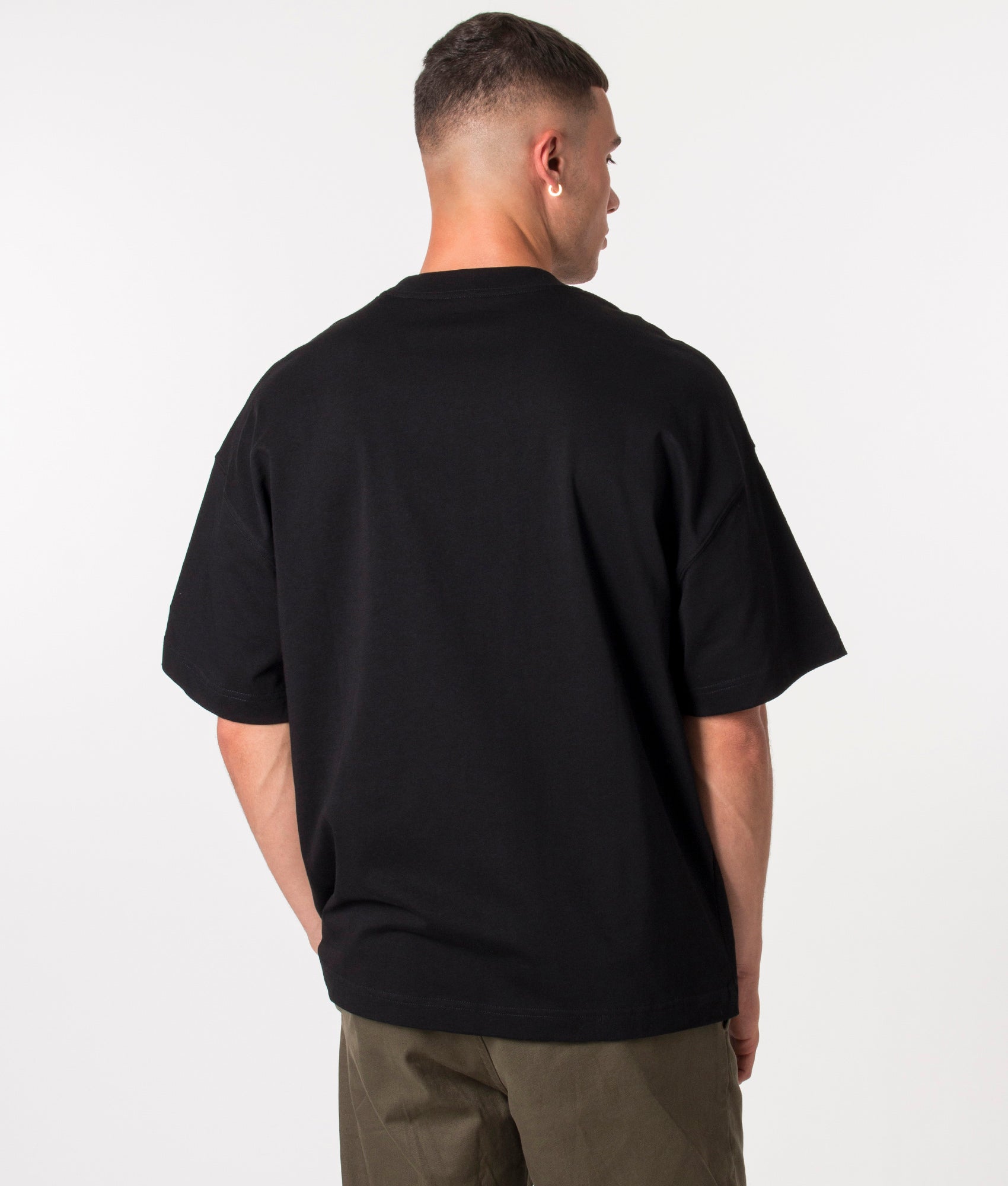Carhartt WIP Relaxed Fit Link Script T-Shirt in Black and White at EQVVS Menswear. Model Back shot.