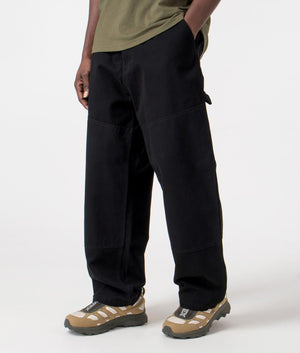 Carhartt WIP Relaxed Fit Wide Panel Pants in Black Rinsed, 100% Cotton Model Angle Shot at EQVVS