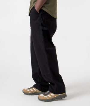 Carhartt WIP Relaxed Fit Wide Panel Pants in Black Rinsed, 100% Cotton Model Side Shot at EQVVS
