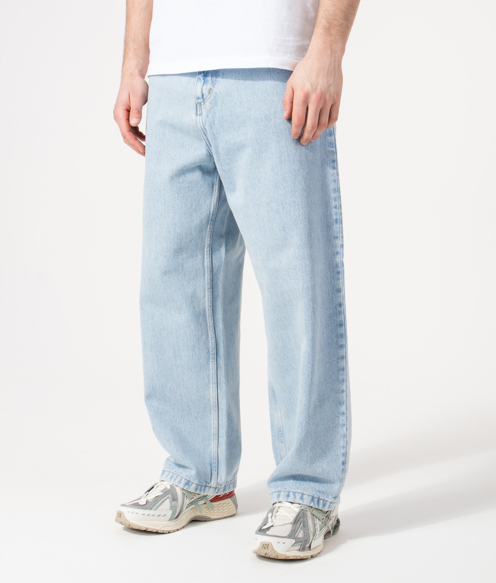 Carhartt WIP Relaxed Fit Brandon Jeans in  Blue Heavy Stone Bleached at EQVVS Menswear. Angled model front shot.