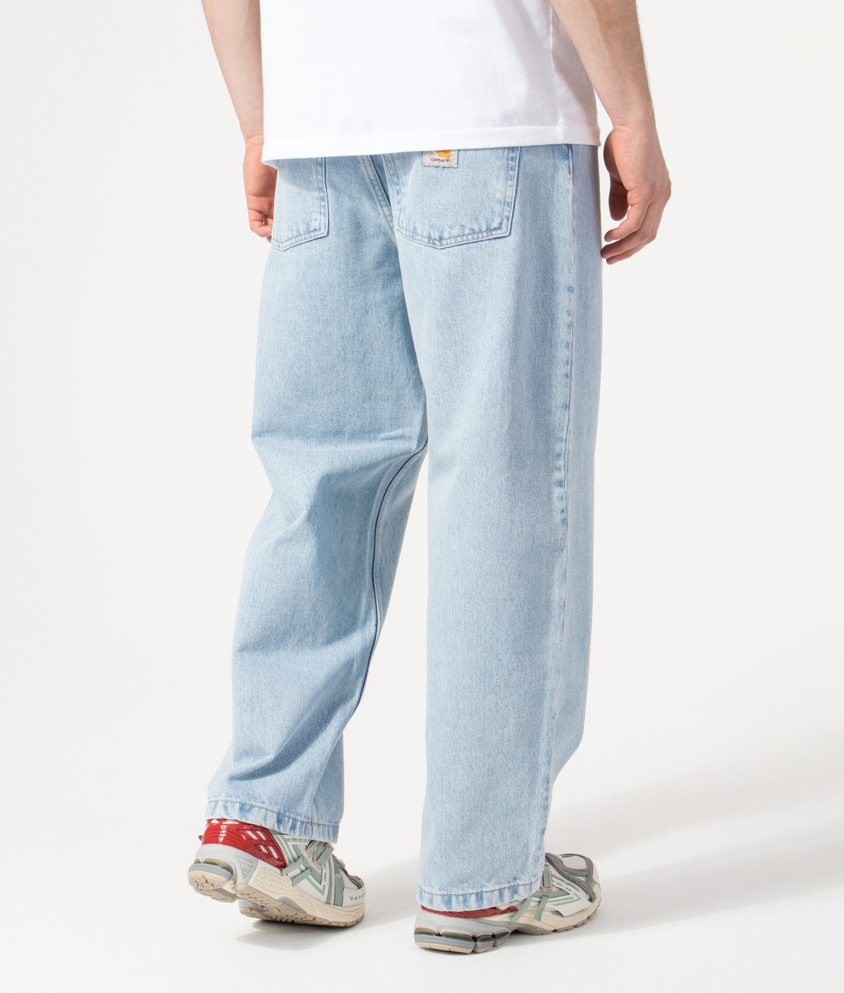 Carhartt WIP Relaxed Fit Brandon Jeans in  Blue Heavy Stone Bleached at EQVVS Menswear. Model back shot.