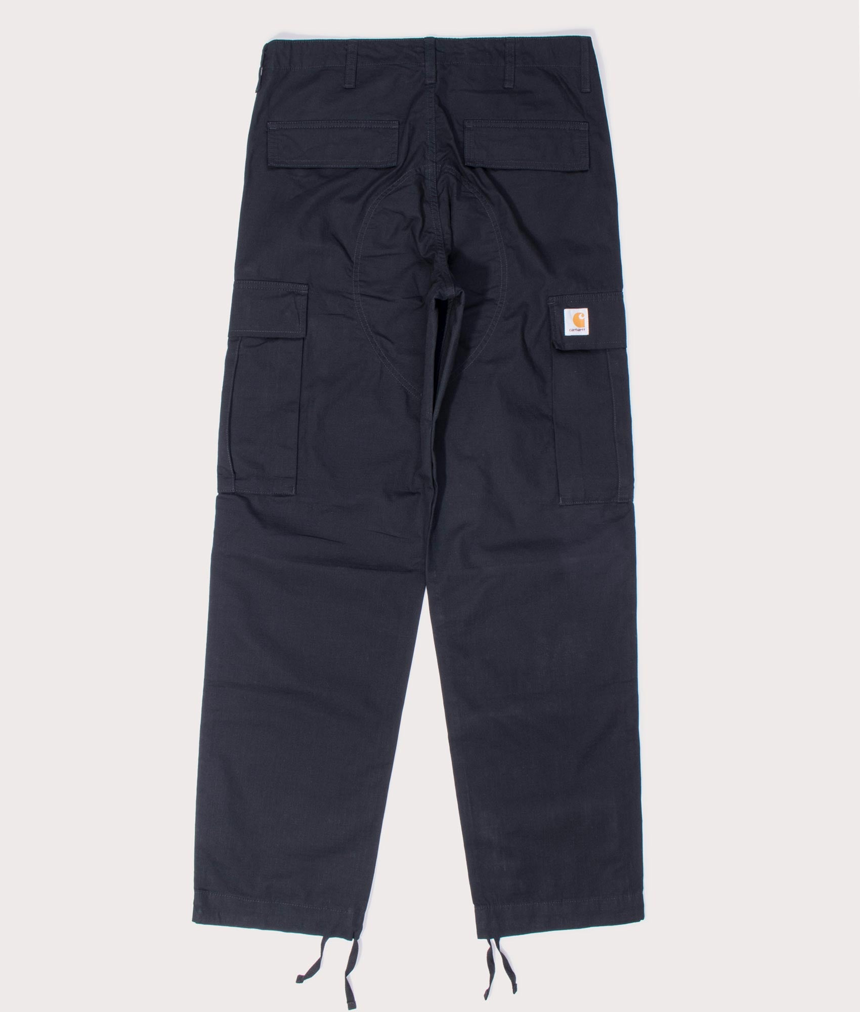 Carhartt Regular Fit Cargo Pants in Black at EQVVS Menswear. Flat back shot.