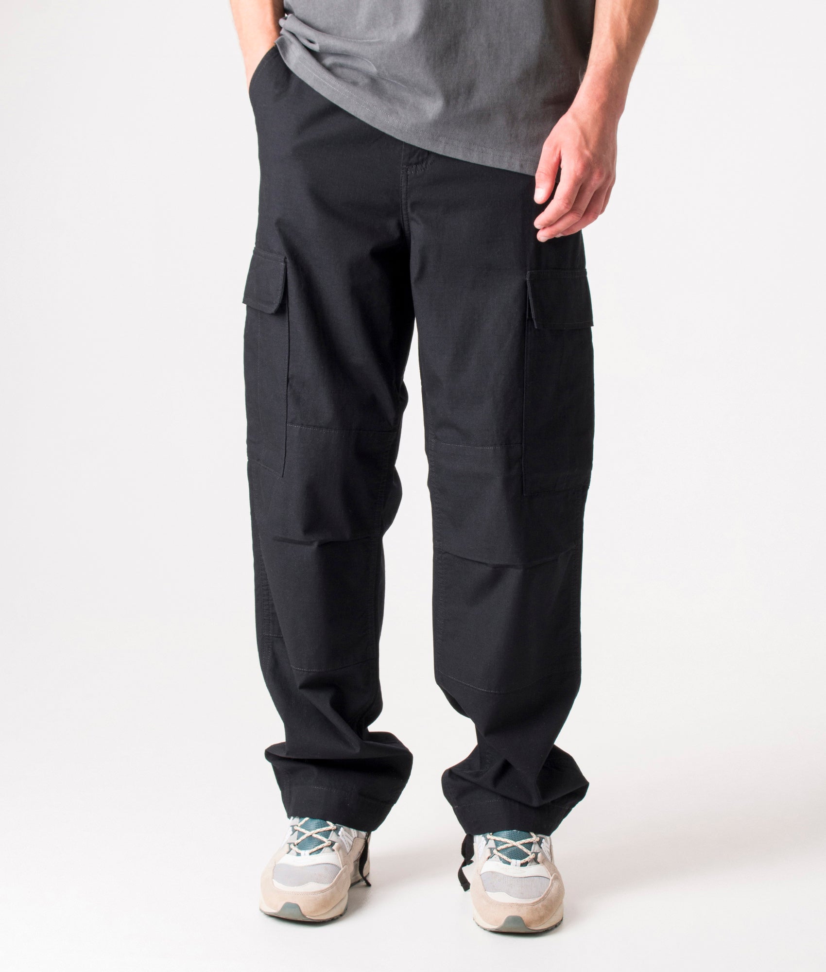 Carhartt Regular Fit Cargo Pants in Black at EQVVS Menswear. Model front shot.