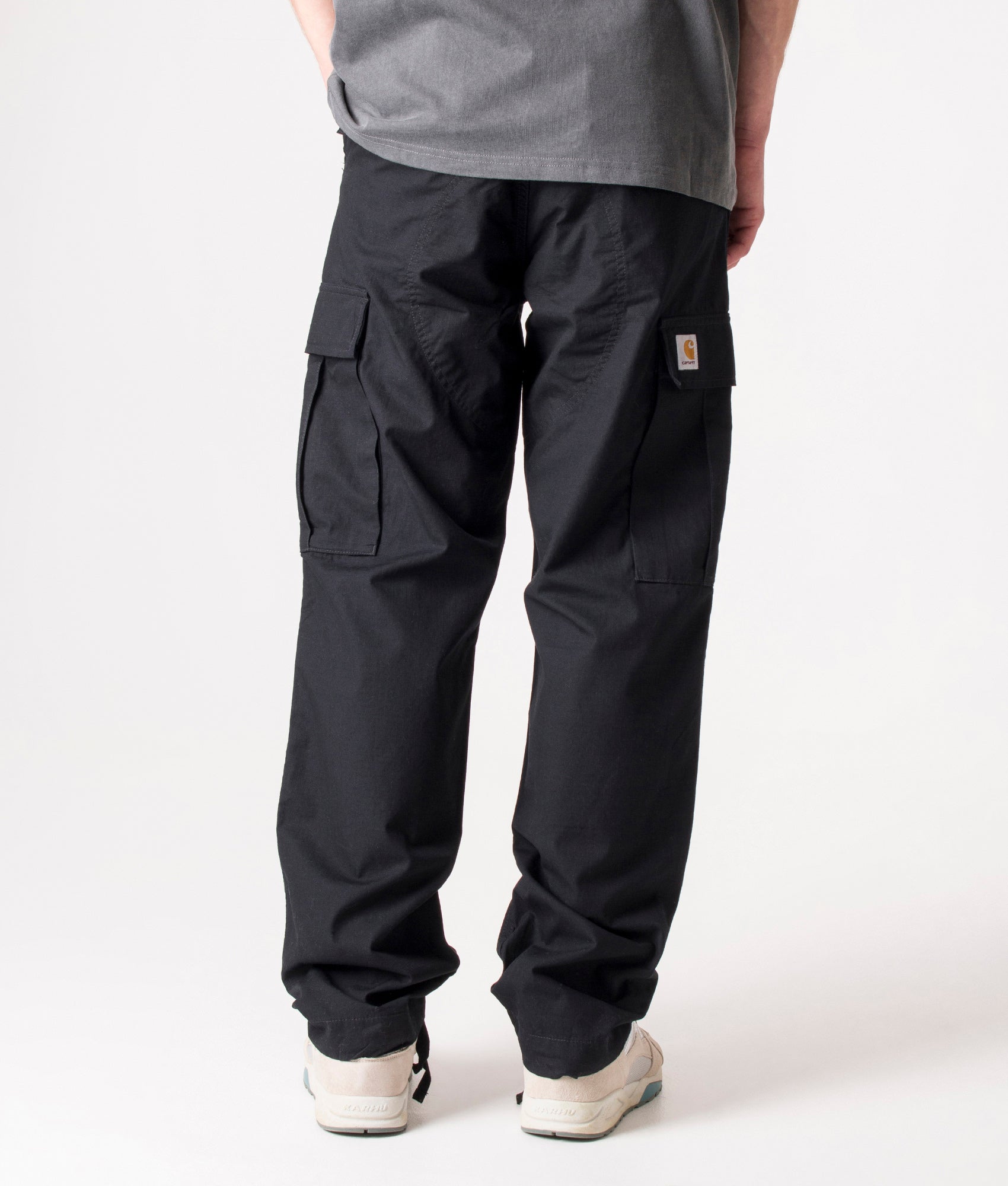 Carhartt Regular Fit Cargo Pants in Black at EQVVS Menswear. Back shot.