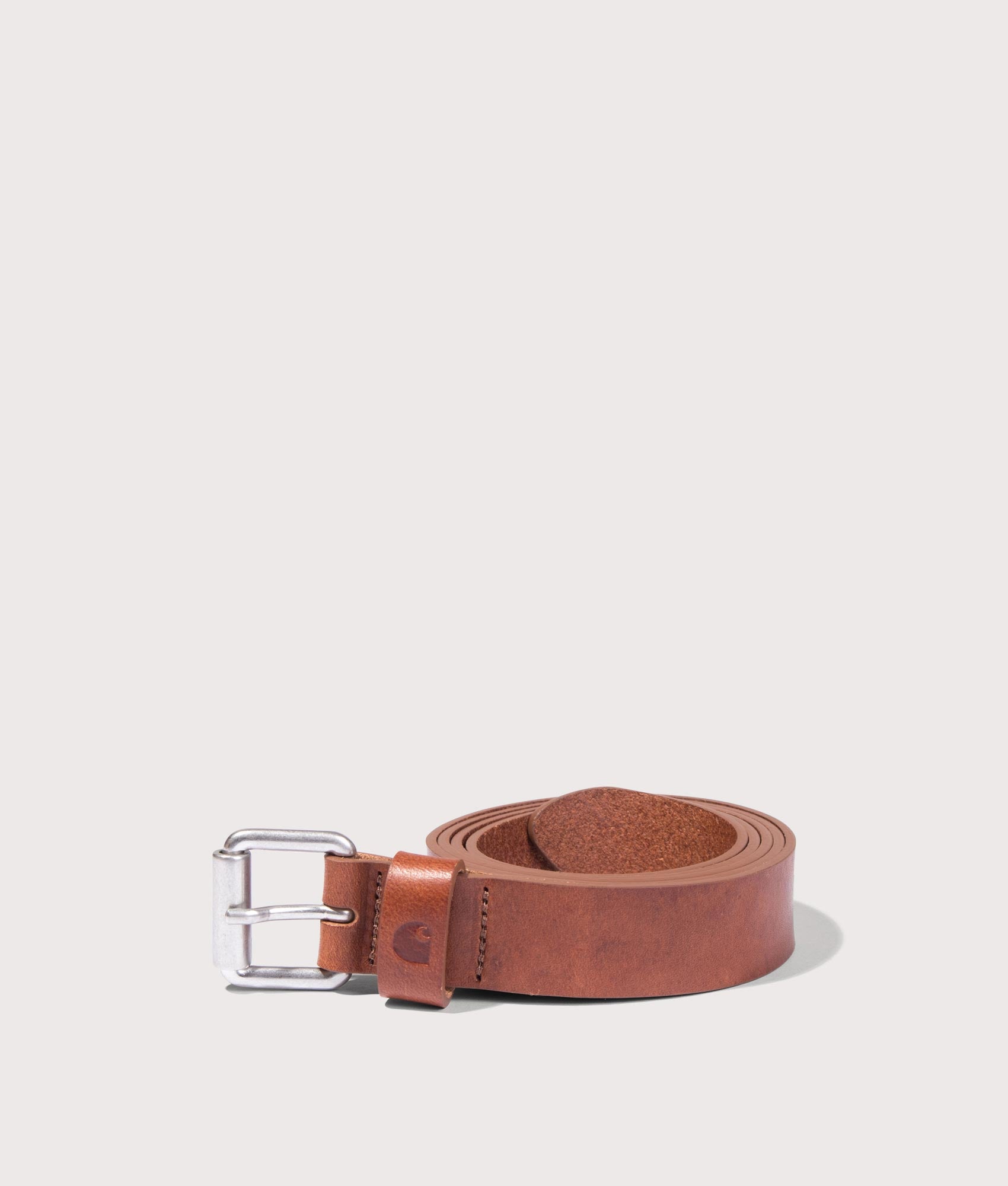 Carhartt WIP Ryan Belt in Cognac and Silver at EQVVS Menswear. Rolled shot.