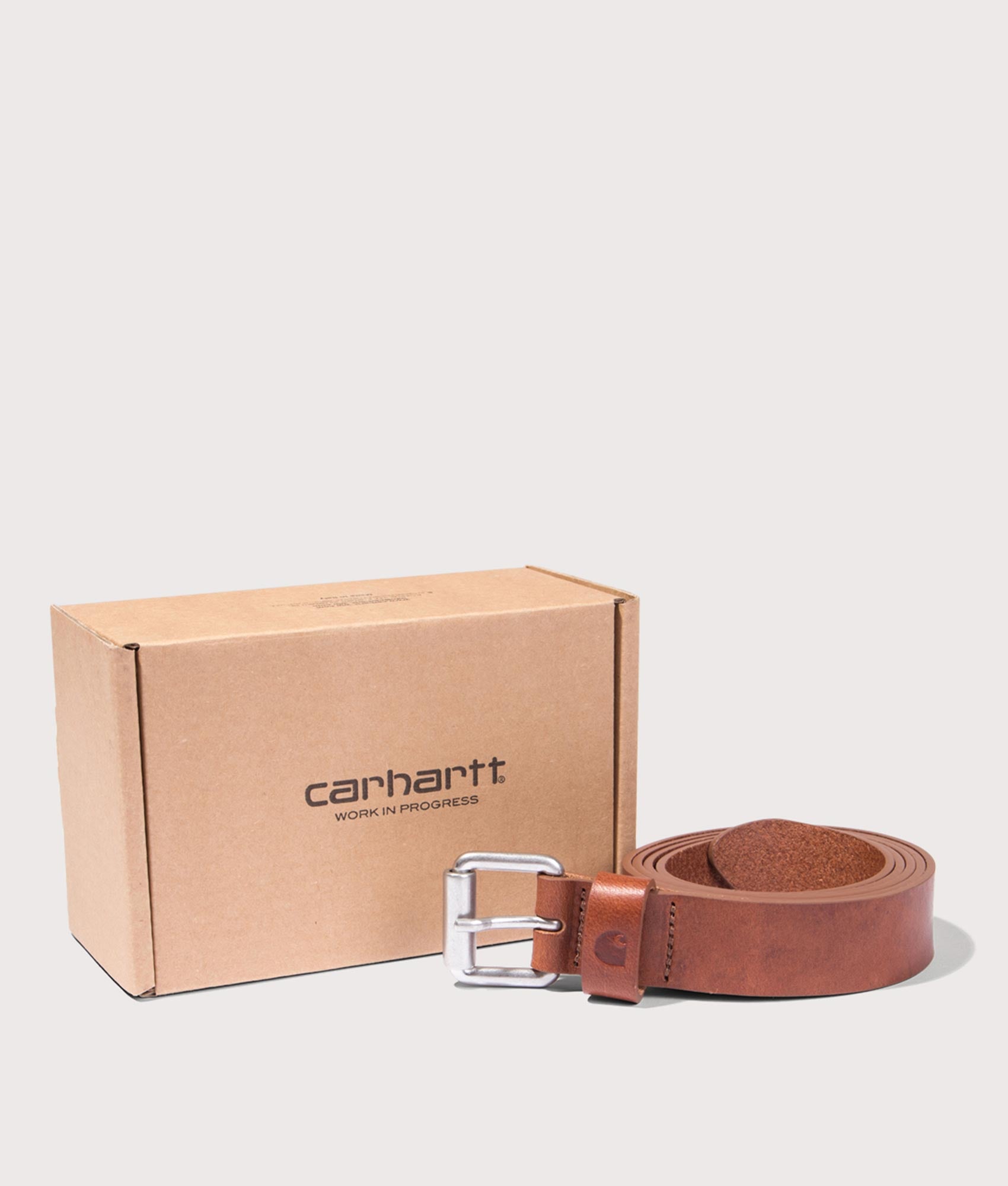 Carhartt WIP Ryan Belt in Cognac and Silver at EQVVS Menswear. Rolled shot with Box 