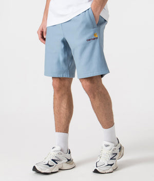 Carhartt WIP Relaxed Fit American Script Sweat Shorts in Frosted Blue Angle Shot at EQVVS
