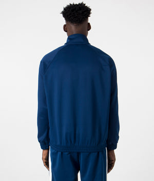 Relaxed Fit Benchill Jacket in Elder & Wax by Carhartt WIP. EQVVS Back Angle Shot.
