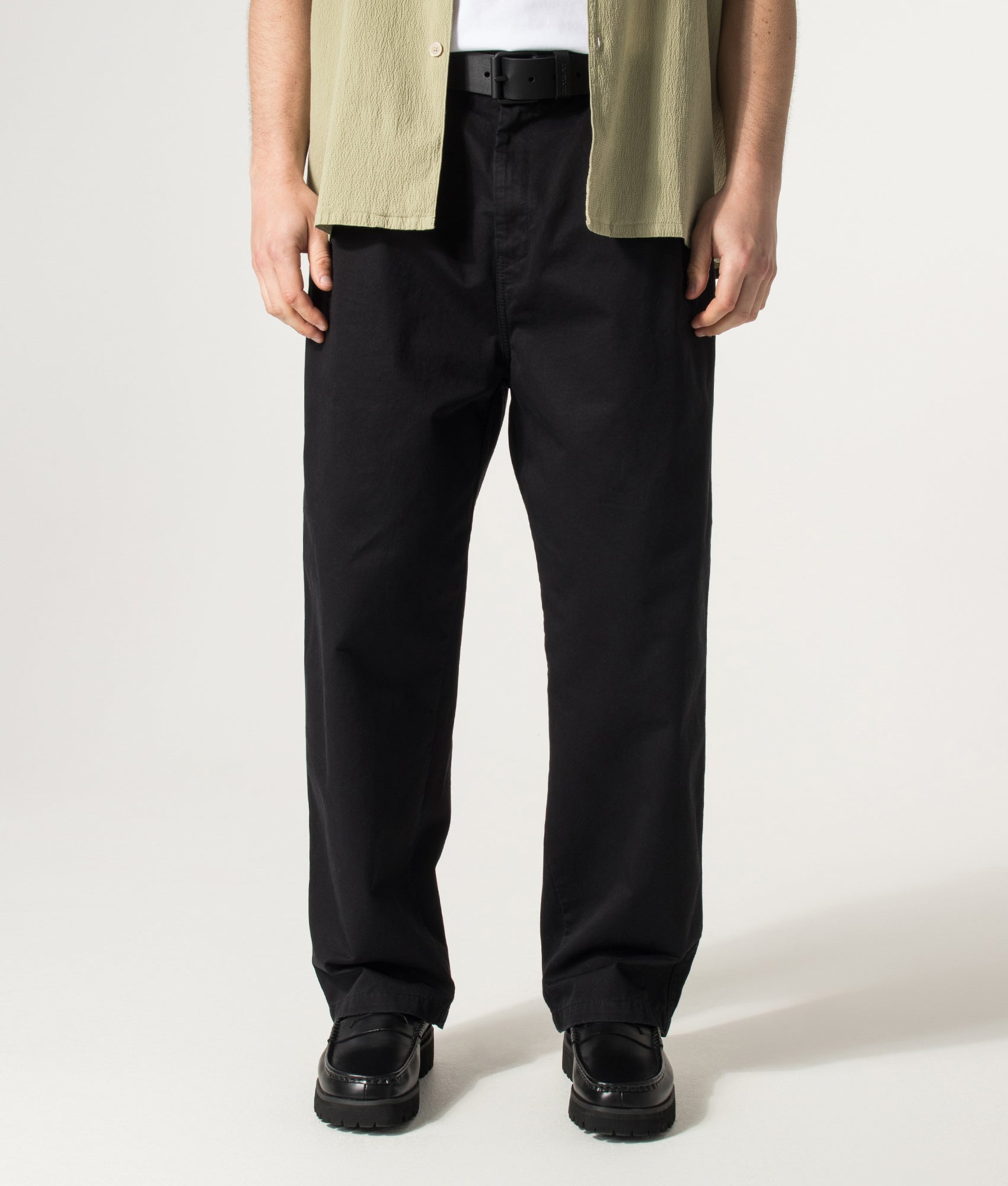 Carhartt WIP Marv Pants in Black Stone Washed at EQVVS Menswear. Model front shot.