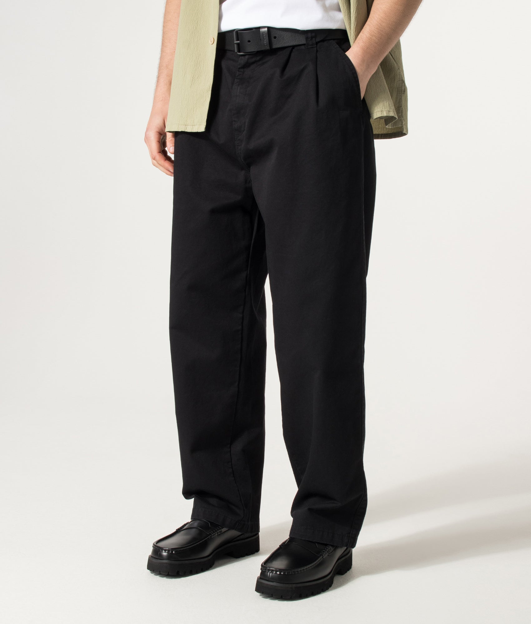 Carhartt WIP Marv Pants in Black Stone Washed at EQVVS Menswear. Angled model front shot.