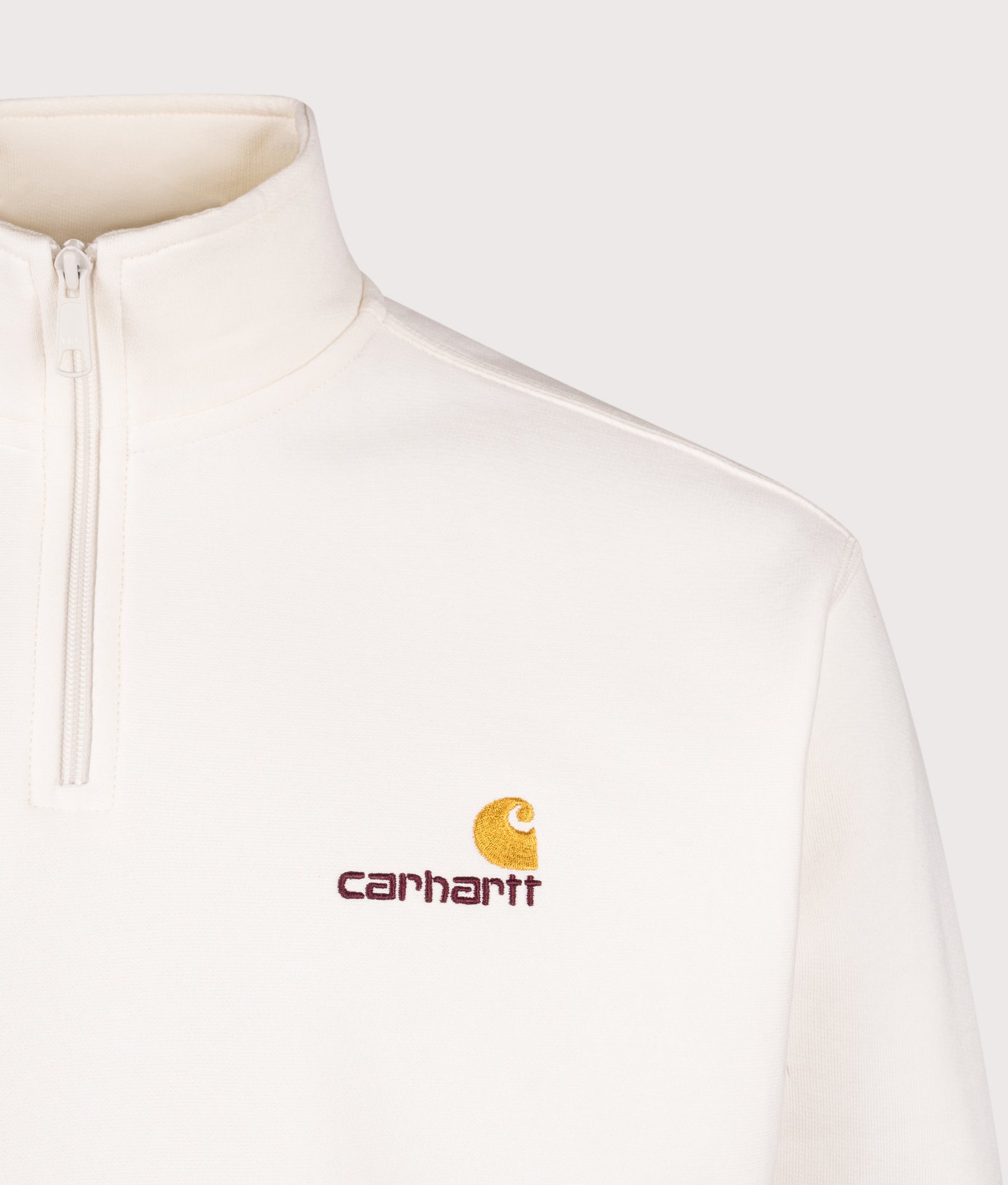 Carhartt WIP styling Relaxed Fit Quarter Zip American Script Sweatshirt in Wax at EQVVS Menswear. Detail shot.