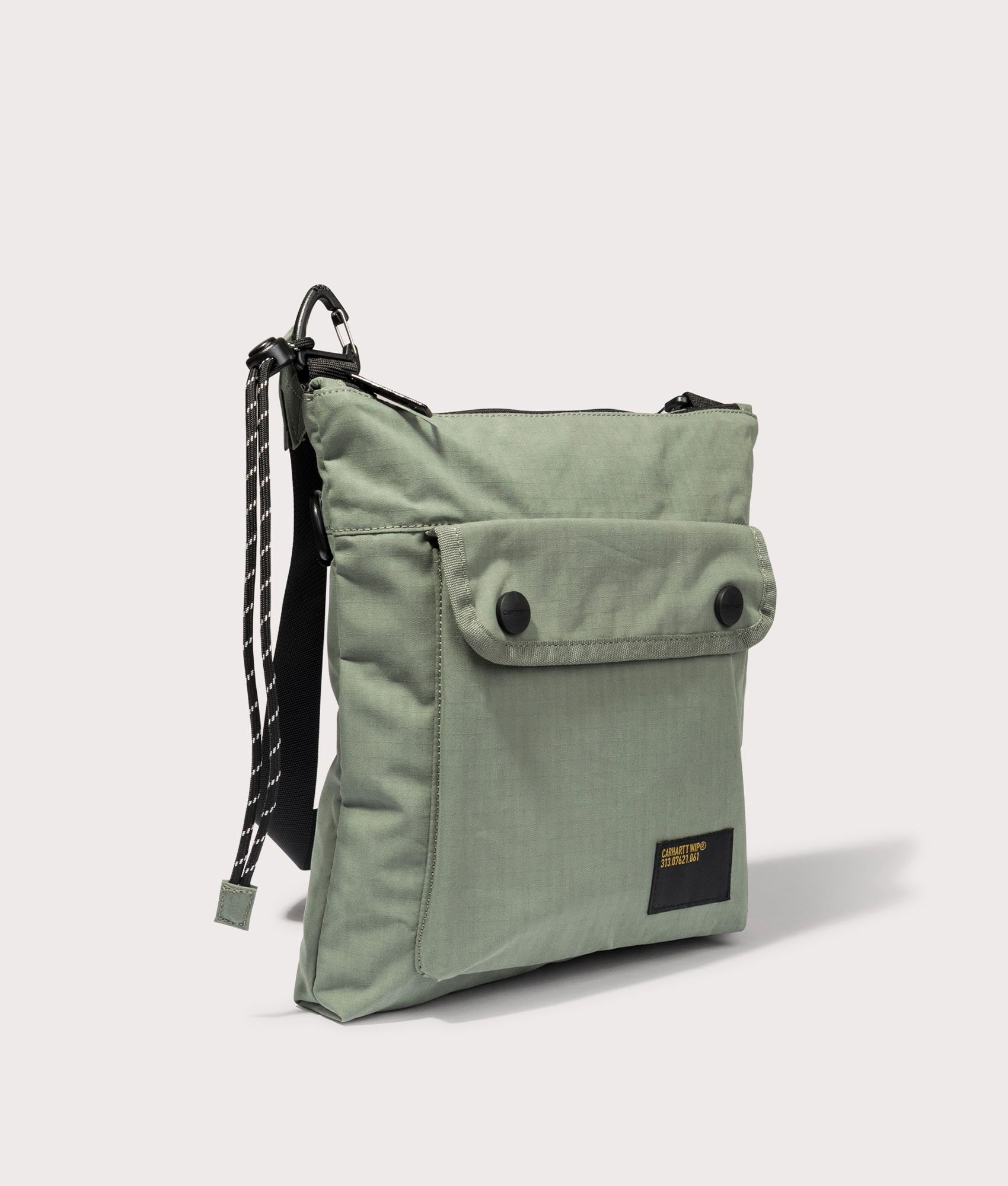 Carhartt WIP Haste Strap Bag in Park. Side angle shot at EQVVS.