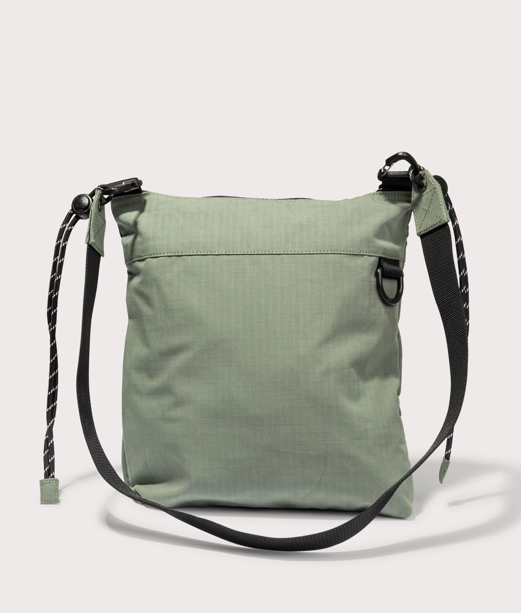 Carhartt WIP Haste Strap Bag in Park. Back angle shot at EQVVS.