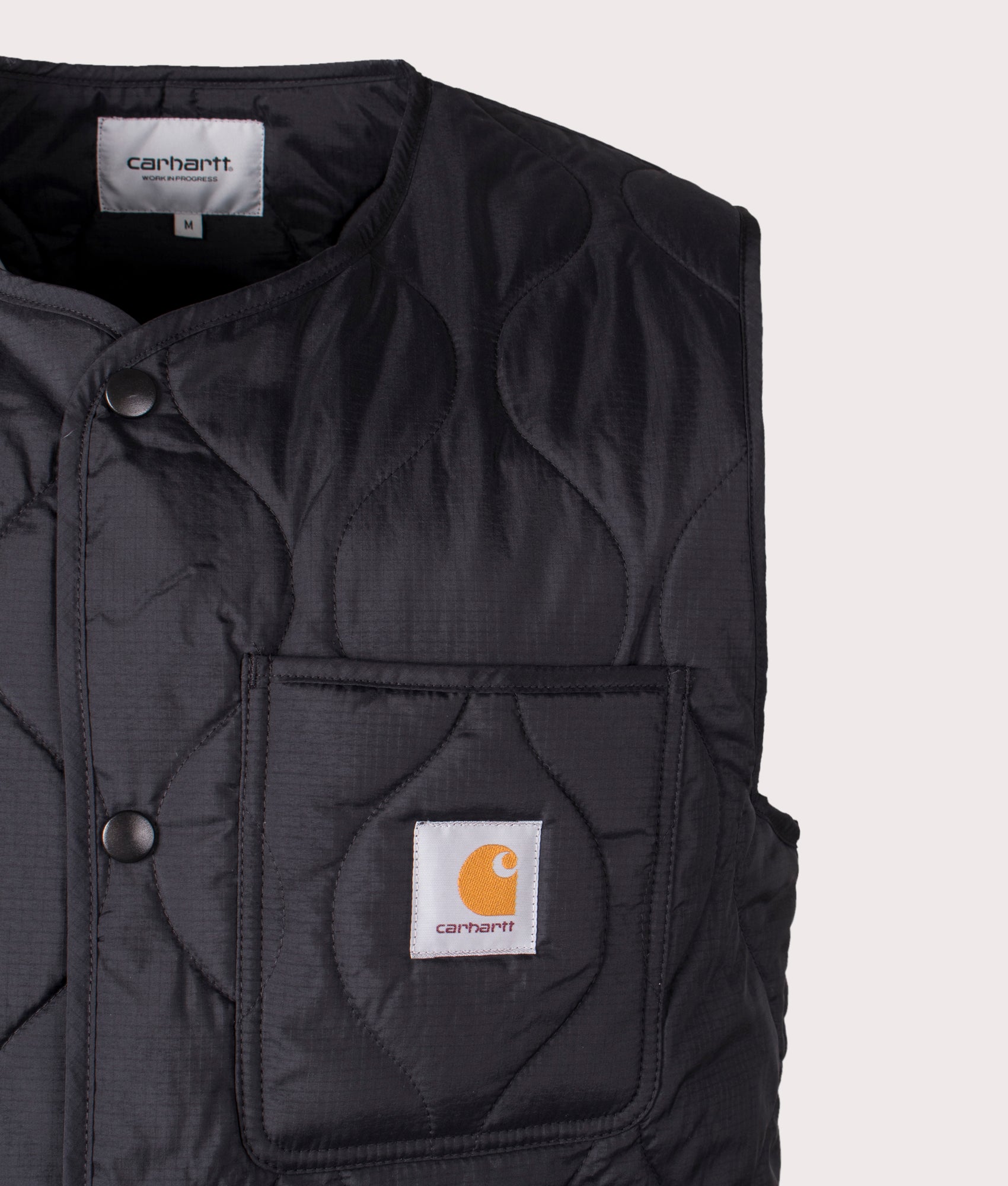 Carhartt WIP Skyton Vest in Black, 100% Recycled Polyester at EQVVS. Close-up shot. 
