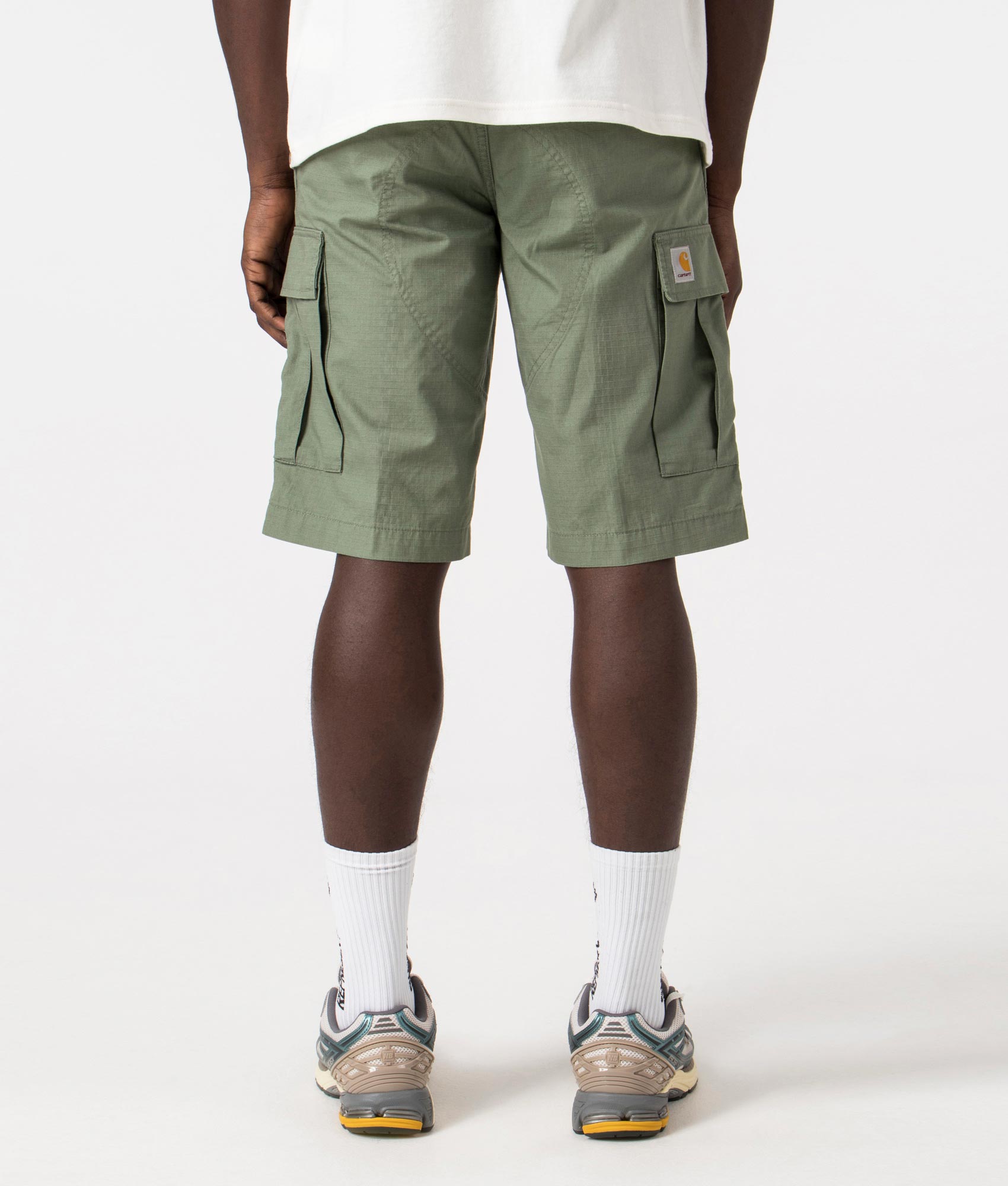 Carhartt WIP Regular Cargo Shorts in Park Green, 100% Cotton. Back Model Shot at EQVVS