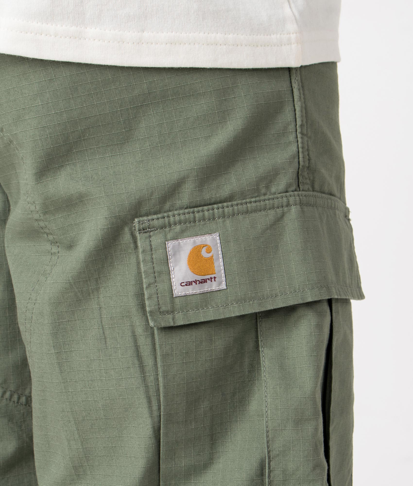 Carhartt WIP Regular Cargo Shorts in Park Green, 100% Cotton. Detail Model Shot at EQVVS