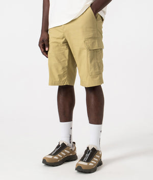 Carhartt WIP Regular Cargo Shorts in Agate Beige, 100% Cotton. Angle Model Shot at EQVVS