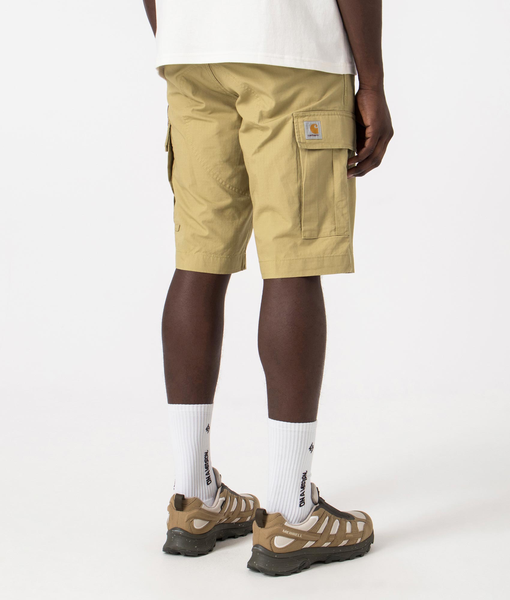 Carhartt WIP Regular Cargo Shorts in Agate Beige, 100% Cotton. Back Model Shot at EQVVS