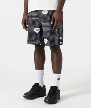 Carhartt WIP Heart Bandana Shorts in Heart Bandana Print Black. Front side angle shot at EQVVS.