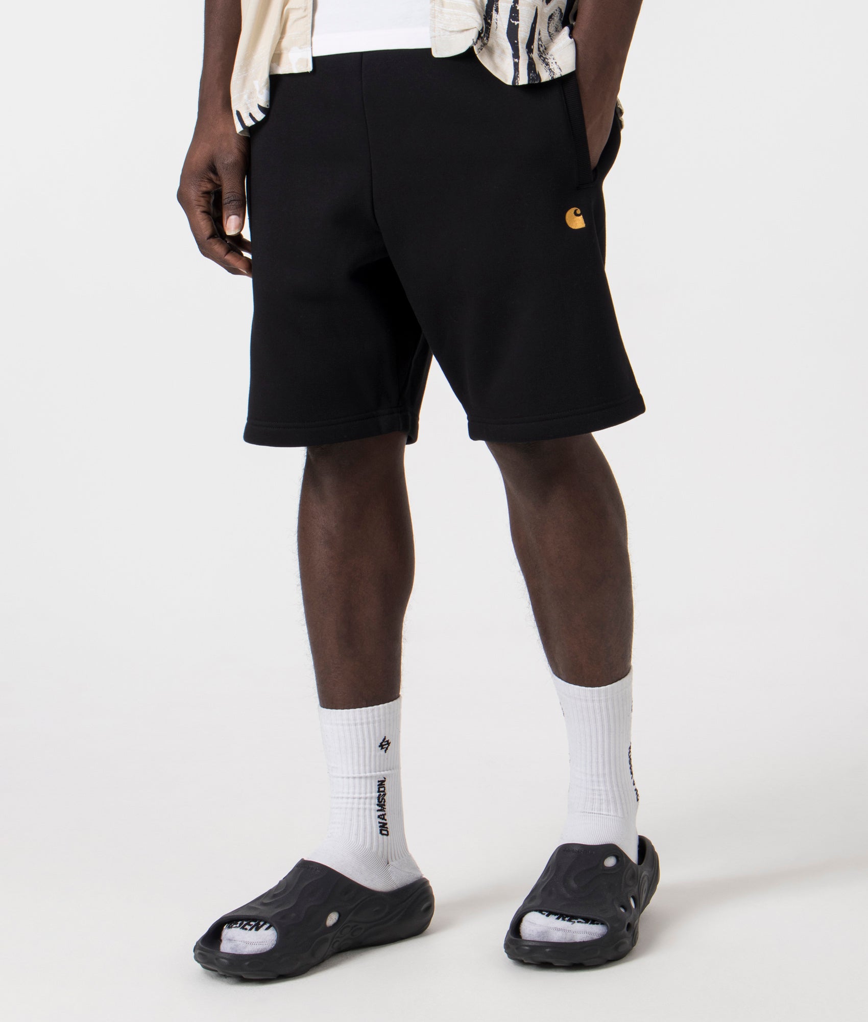 Carhartt WIP Chase Sweat short in 00FXX Black/Gold side front shot at EQVVS