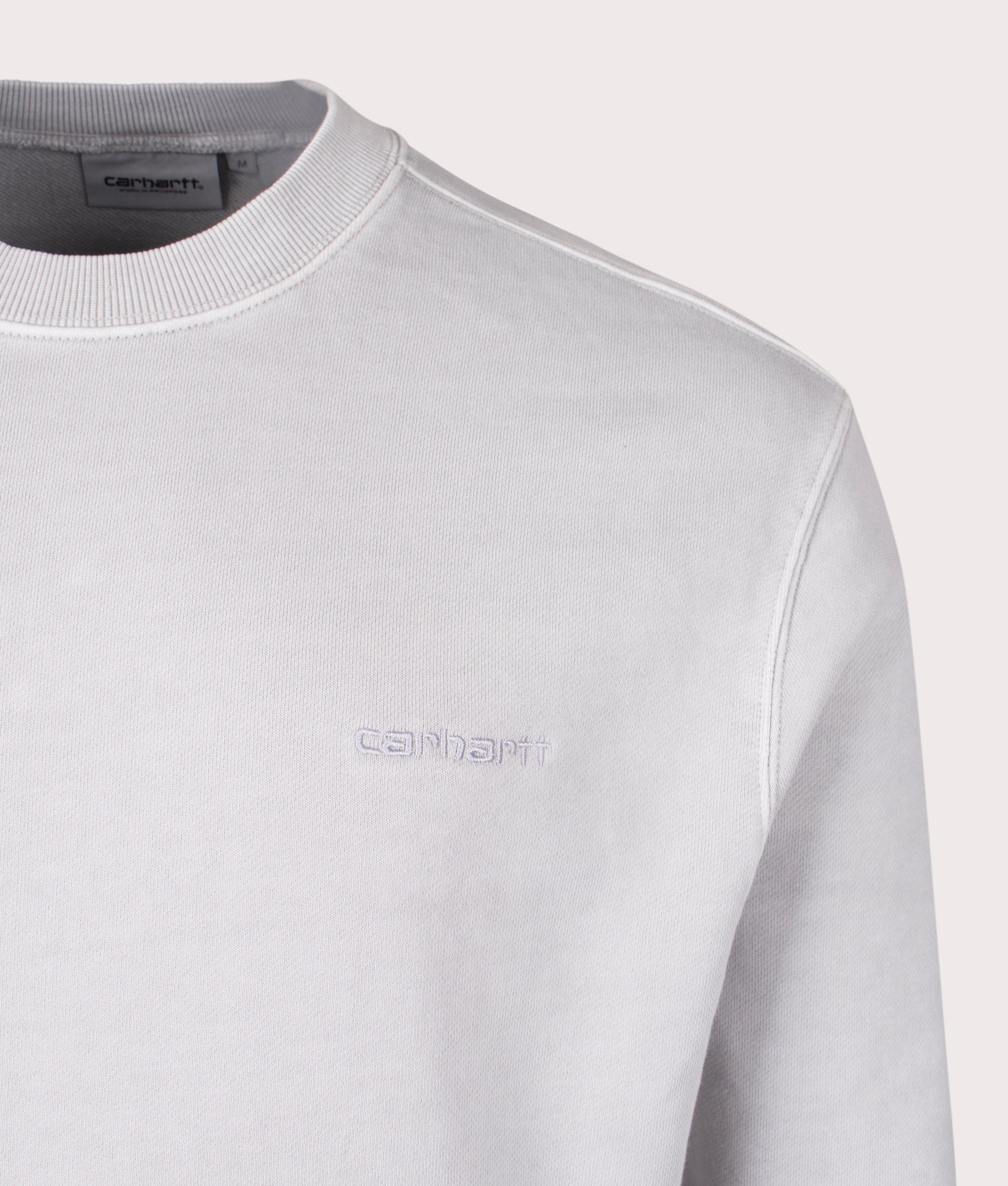 Carhartt WIP Relaxed Fit Duster Script Sweatshirt in Basalt. Detail angle shot at EQVVS.