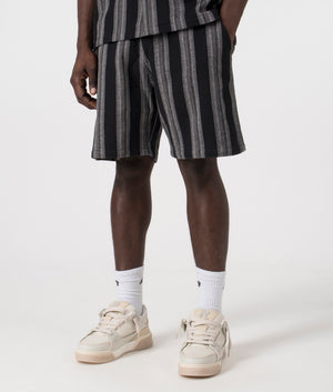 Carhartt WIP Dodson Short in Stripe Black. Side angle model shot at EQVVS.